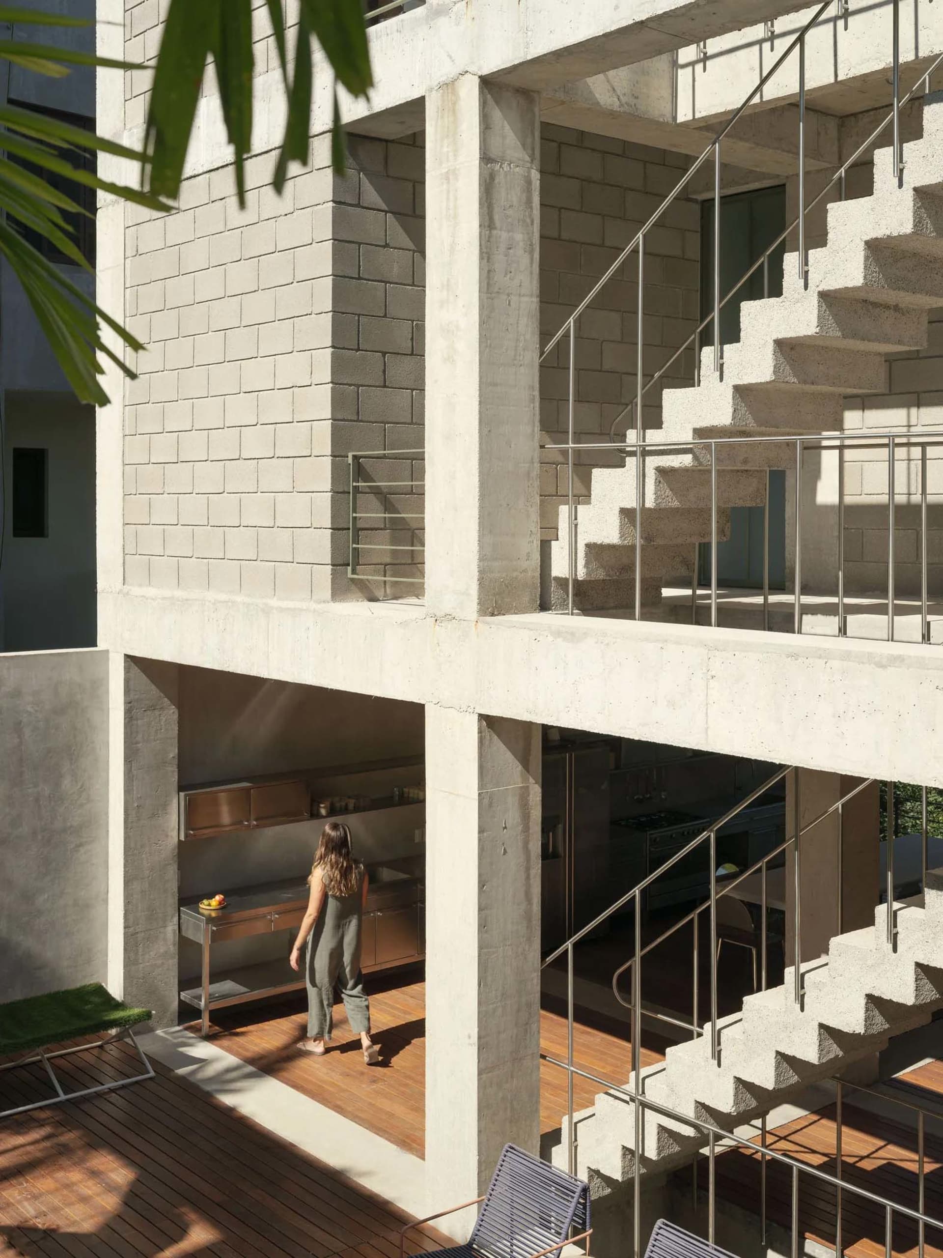 Modern architecture featuring a concrete exterior with stainless steel and wooden elements.