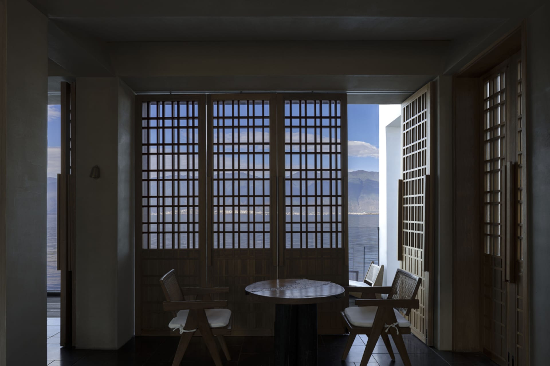 Modern residential space featuring wooden fence and view of the sea
