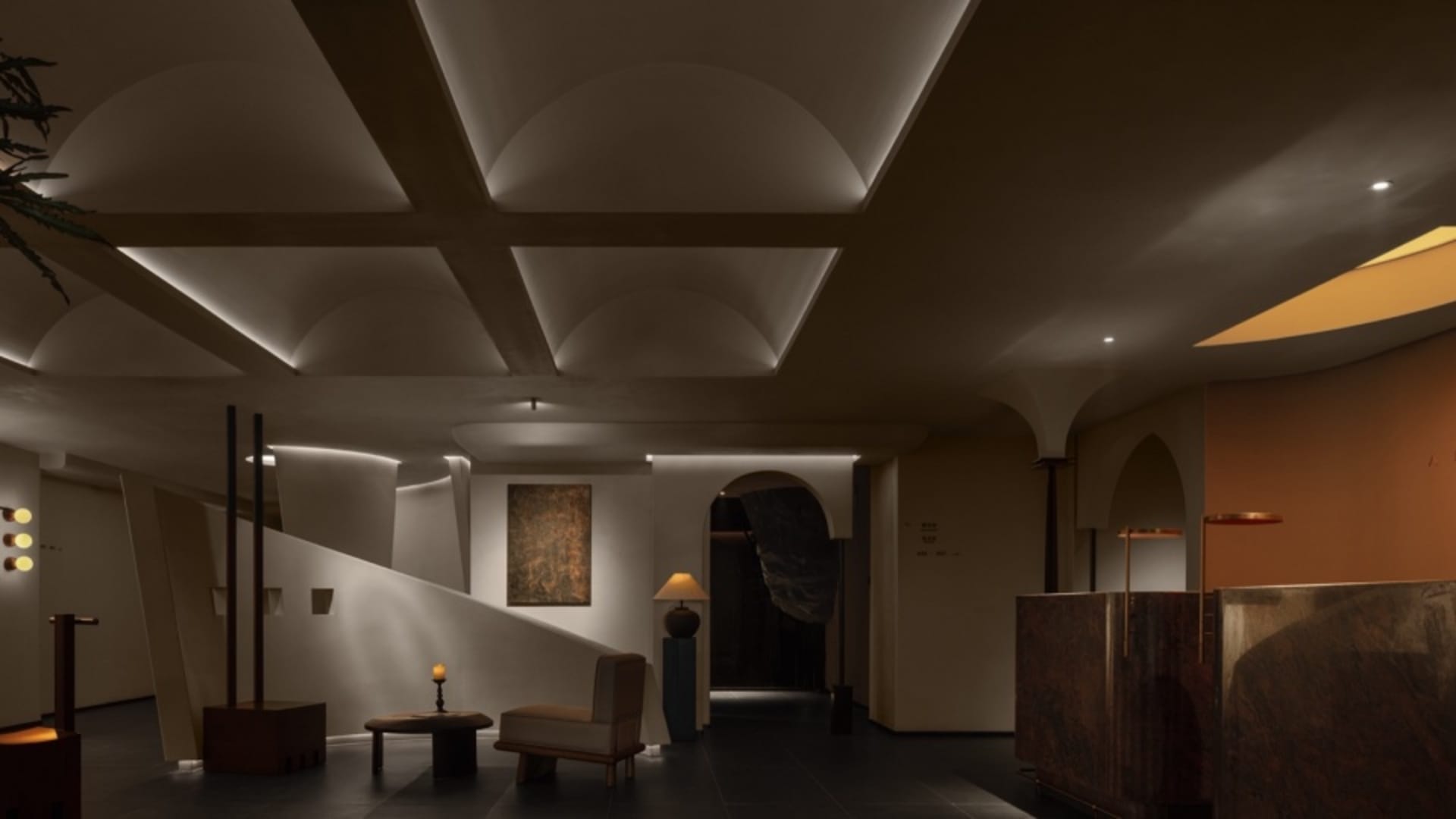 Modern interior lobby featuring exposed concrete walls and ceiling beams