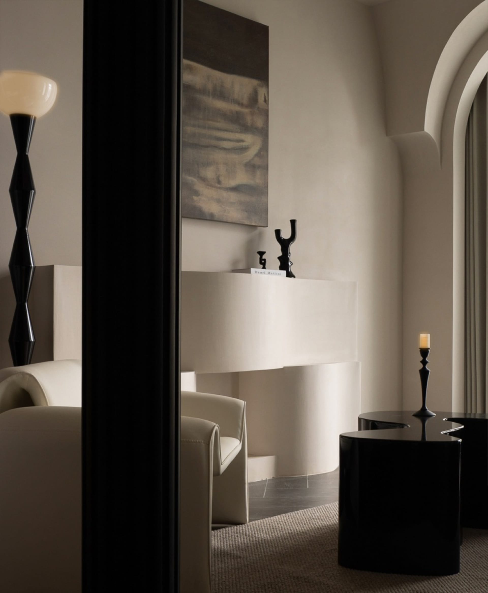 A modern minimalist living room with neutral tones, elegant furniture, and decorative elements.