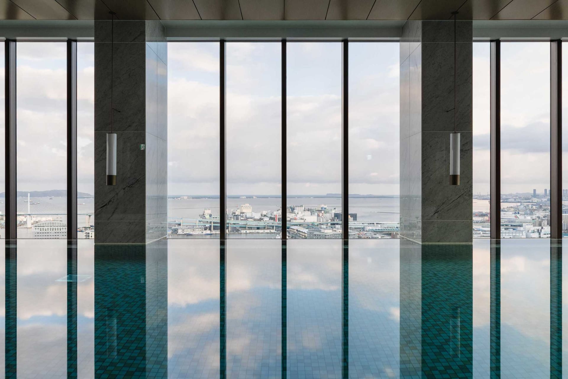 Modern glass pool overlooking a cityscape