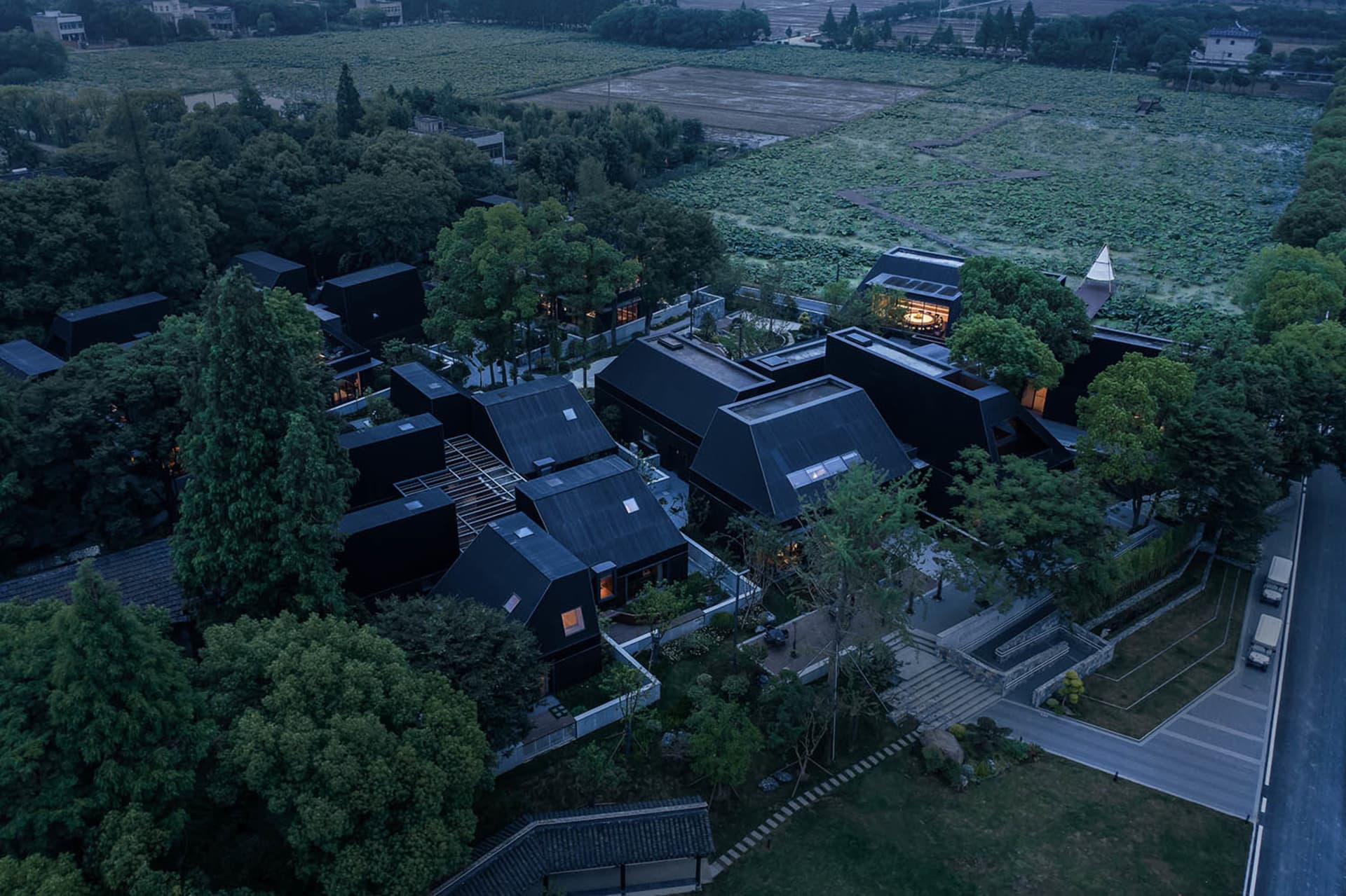 A modern residential building with black metal exterior.