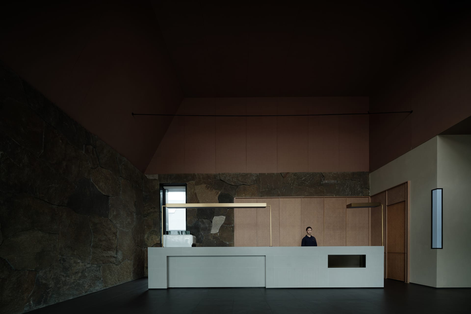 A modern reception desk made of concrete with minimalist design.