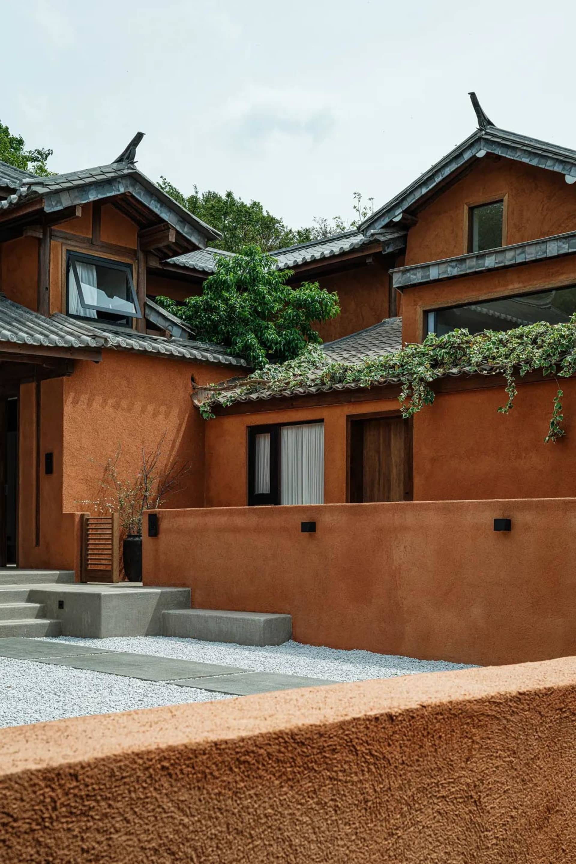 A traditional terracotta home with a red clay roof and exterior walls.
