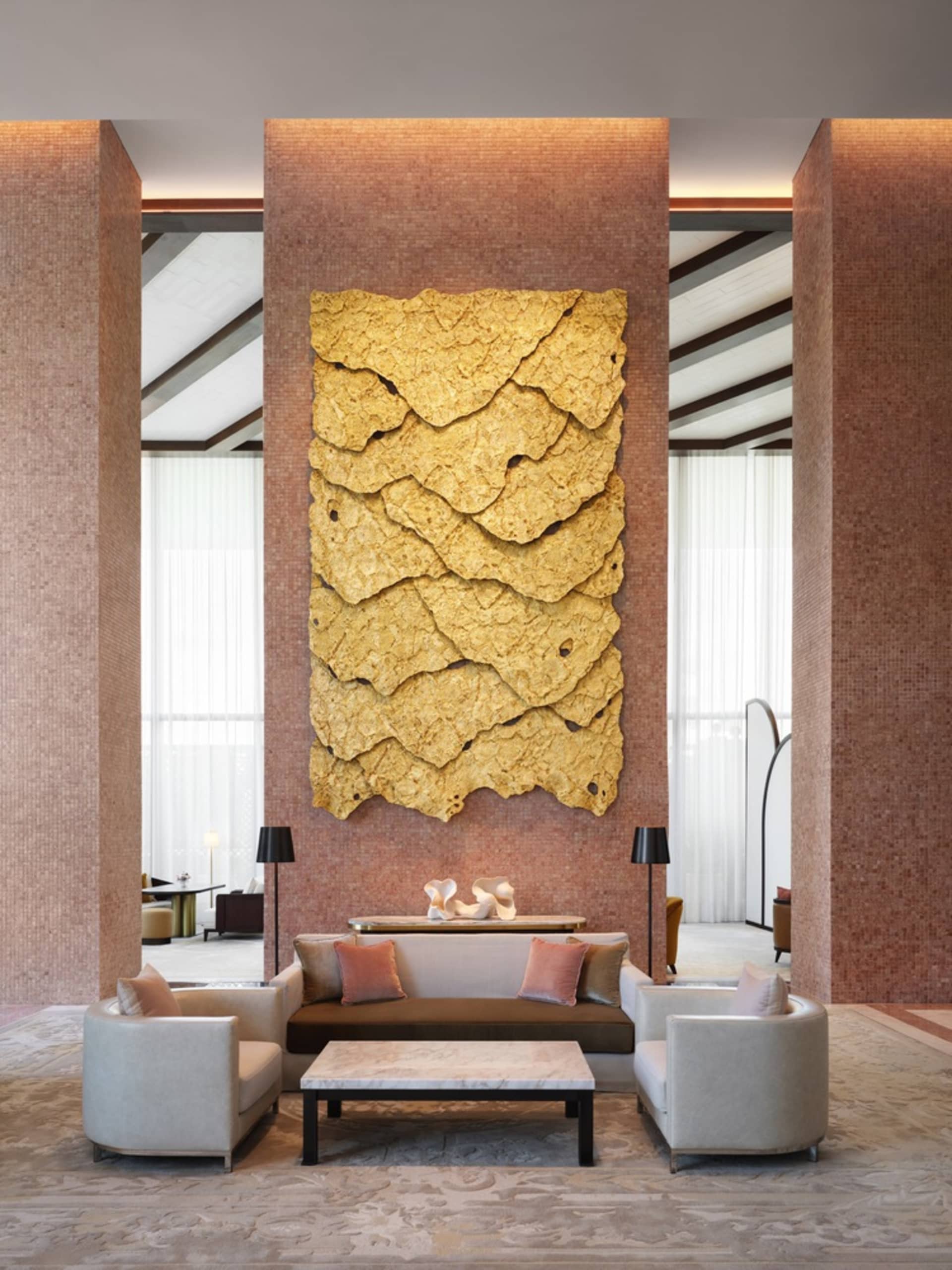 A modern lobby with a contemporary concrete art wall and minimalist seating area
