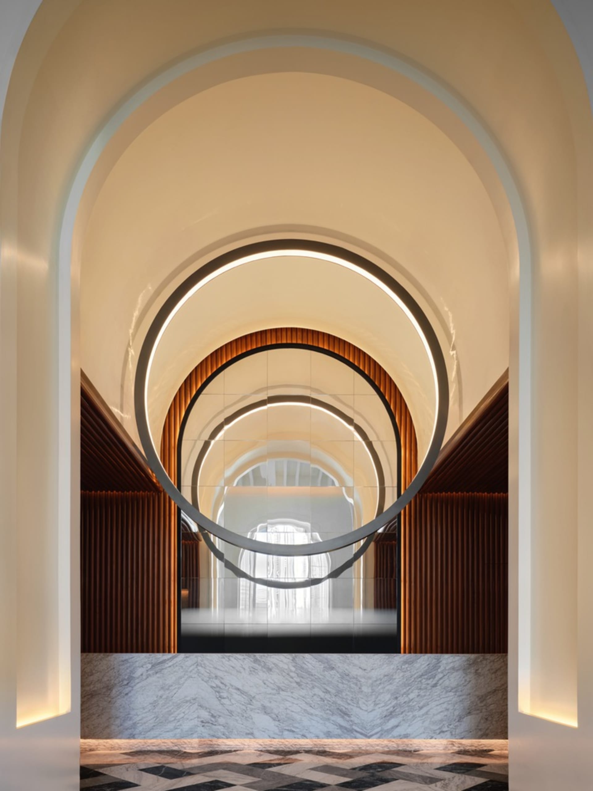 Modern entrance with marble and concrete materials and a circular design element.