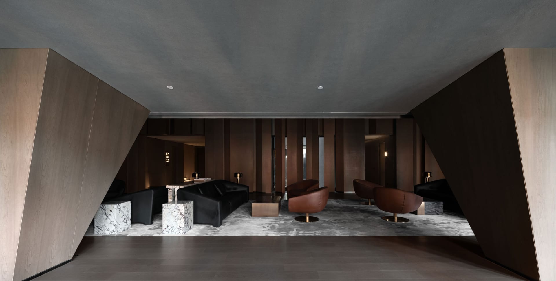 Industrial-style retail lobby with wooden walls and black and brown furniture.