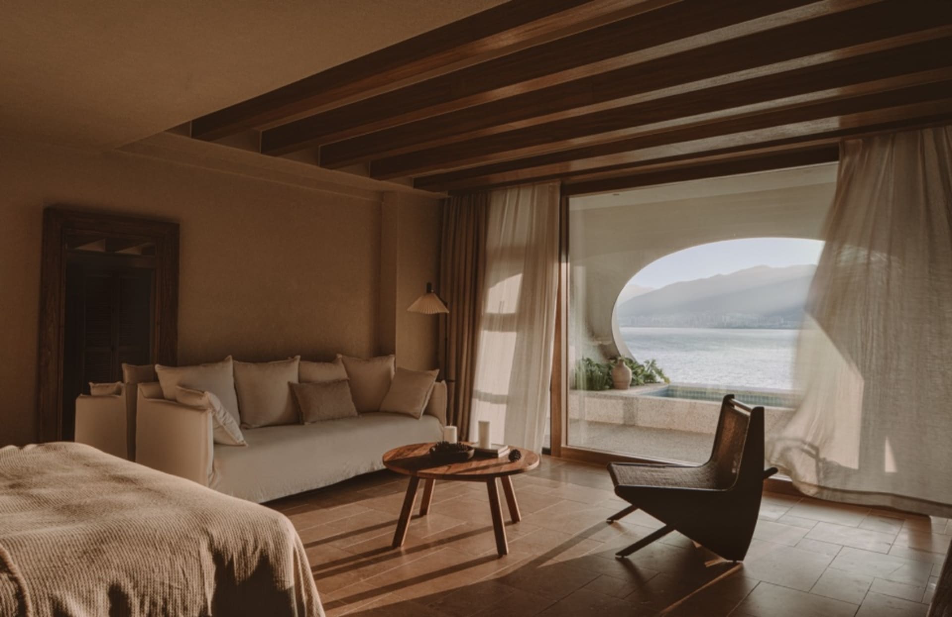 A minimalist bedroom featuring curtains and wooden furniture.
