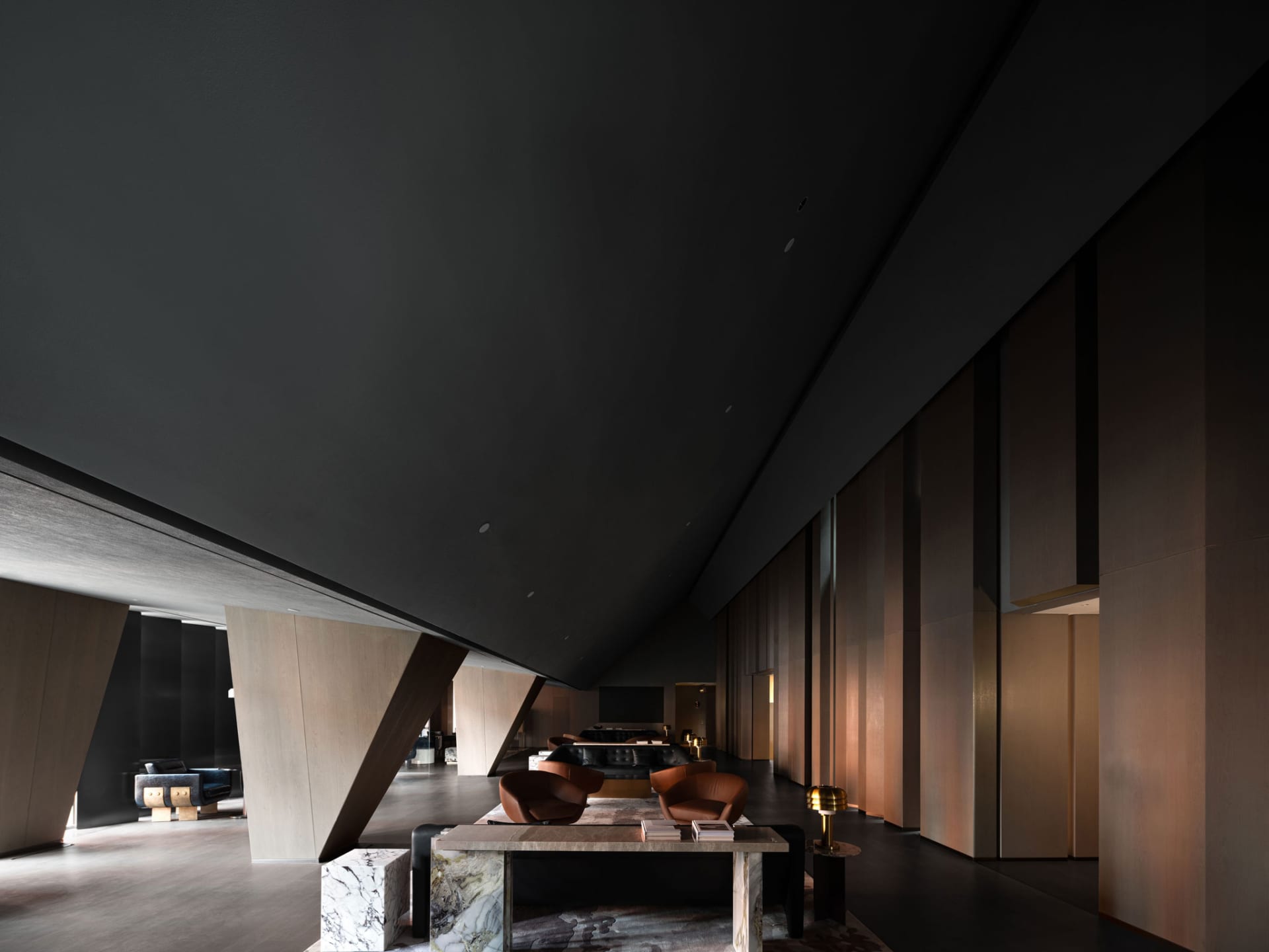 A modern minimalist lobby featuring marble and wood materials.