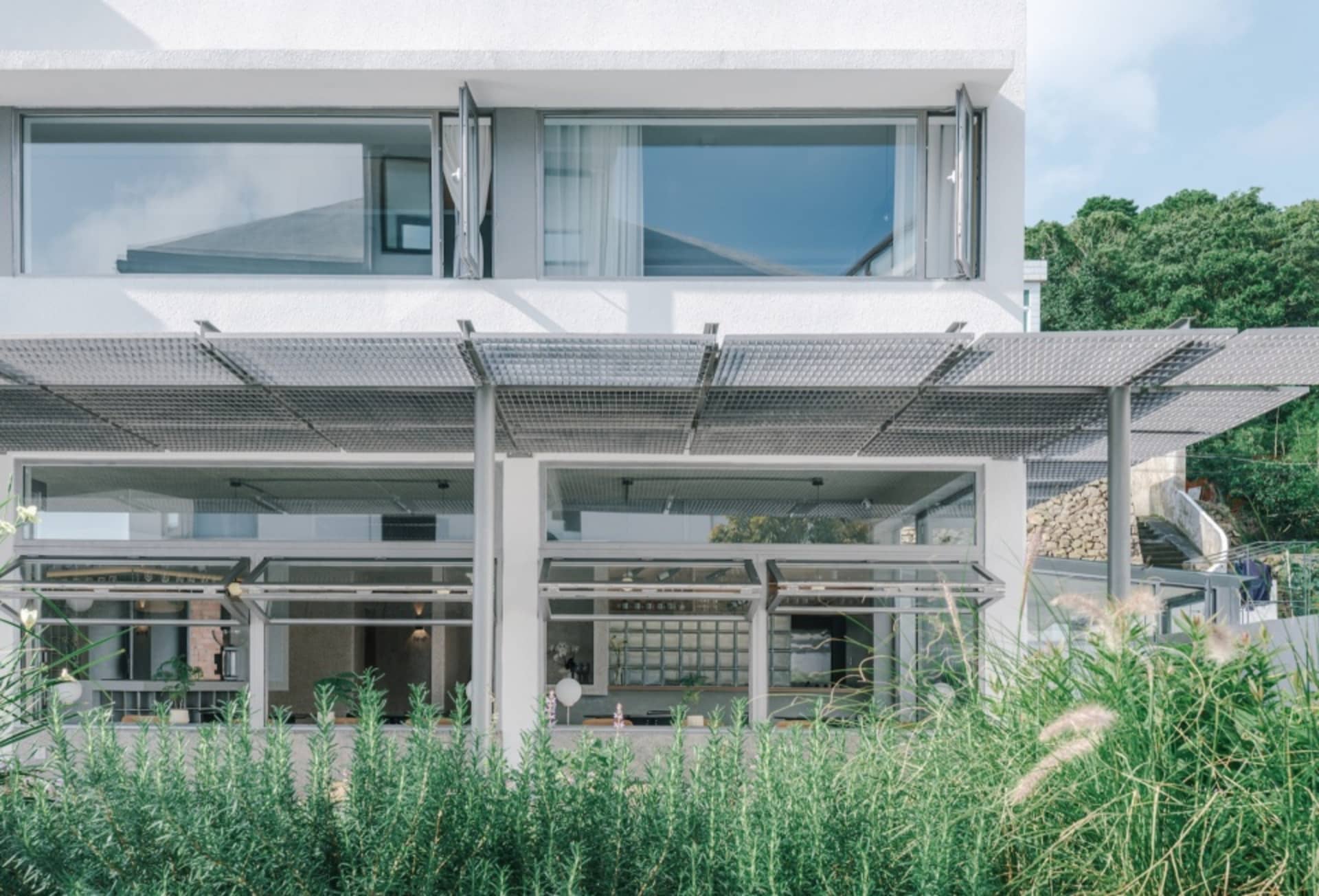 The contemporary design of a residential building featuring raw concrete materials and a minimalist aesthetic.