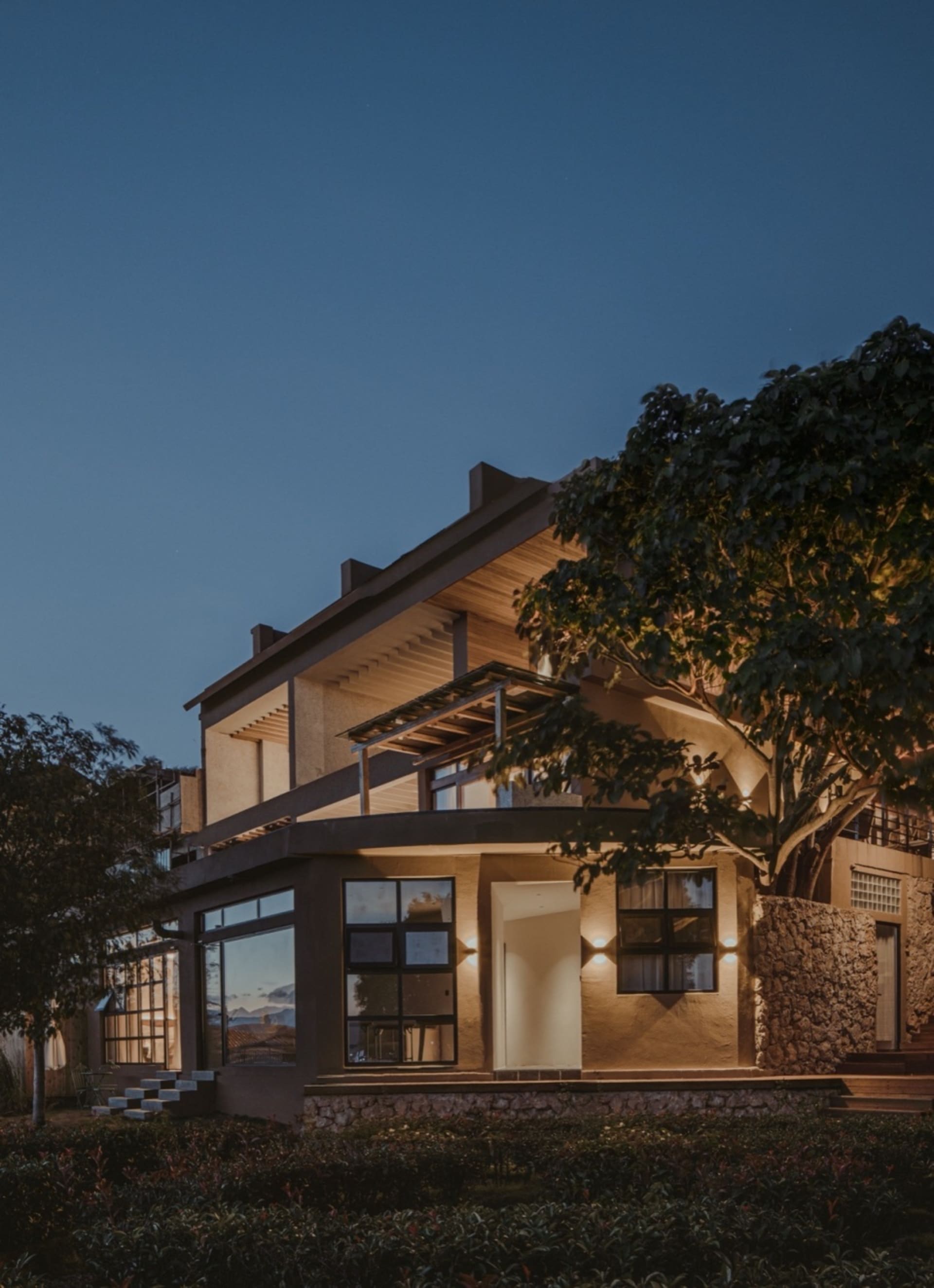 Modern residential exterior with concrete and stone materials.
