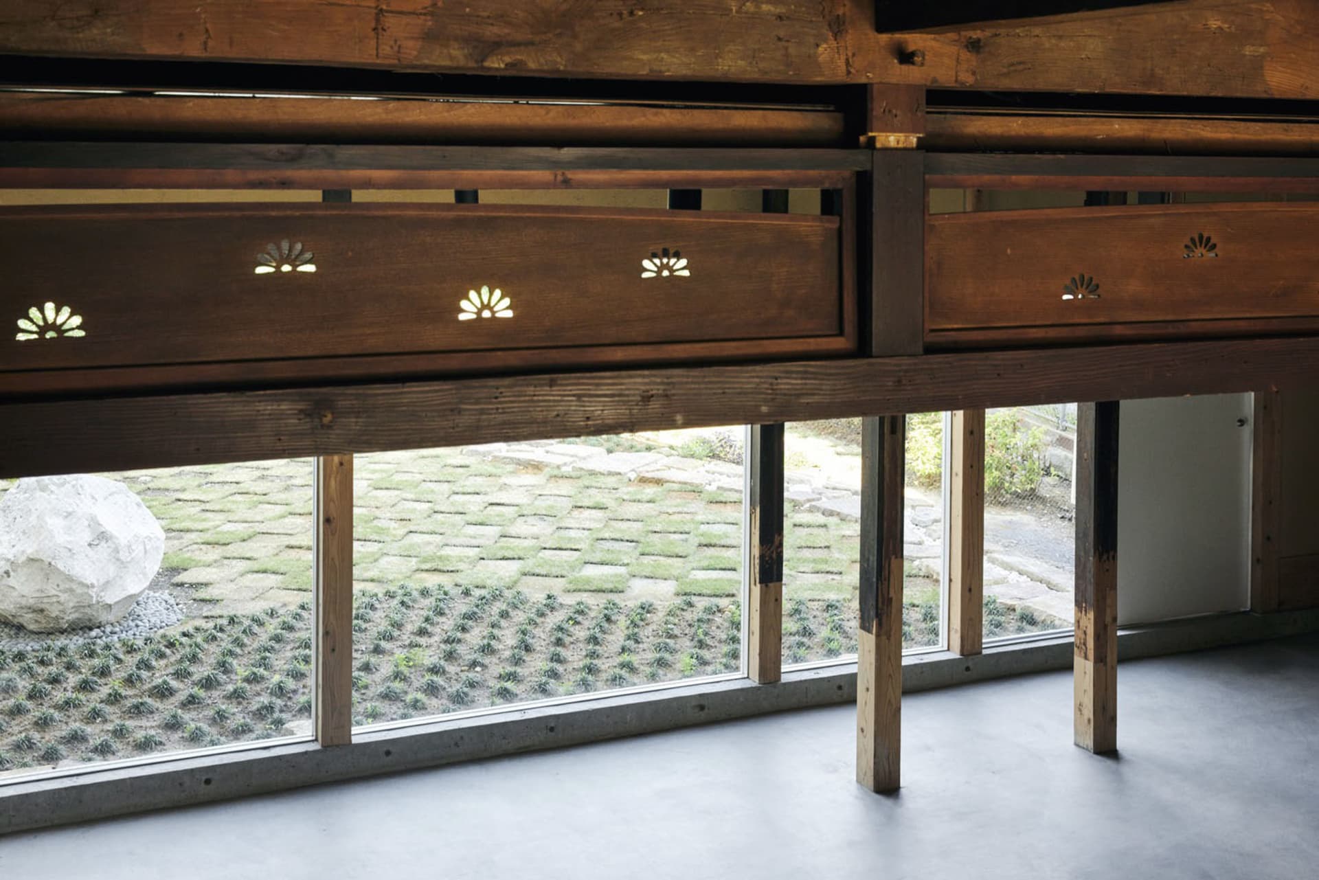 Interior space featuring modern design elements such as wooden beams and glass panels.