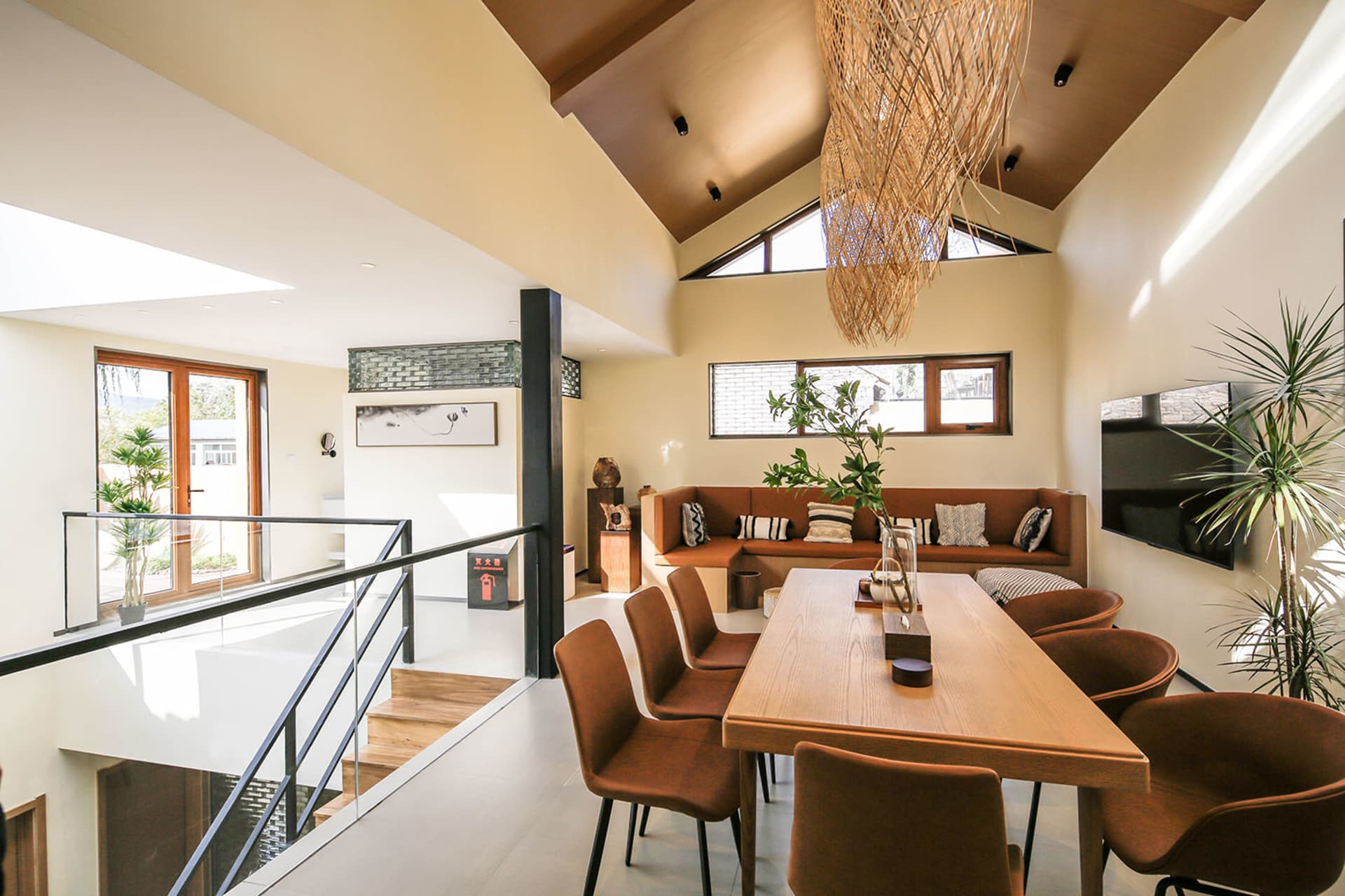 Modern residential living space featuring a concrete floor and wooden furniture with a warm and inviting atmosphere.