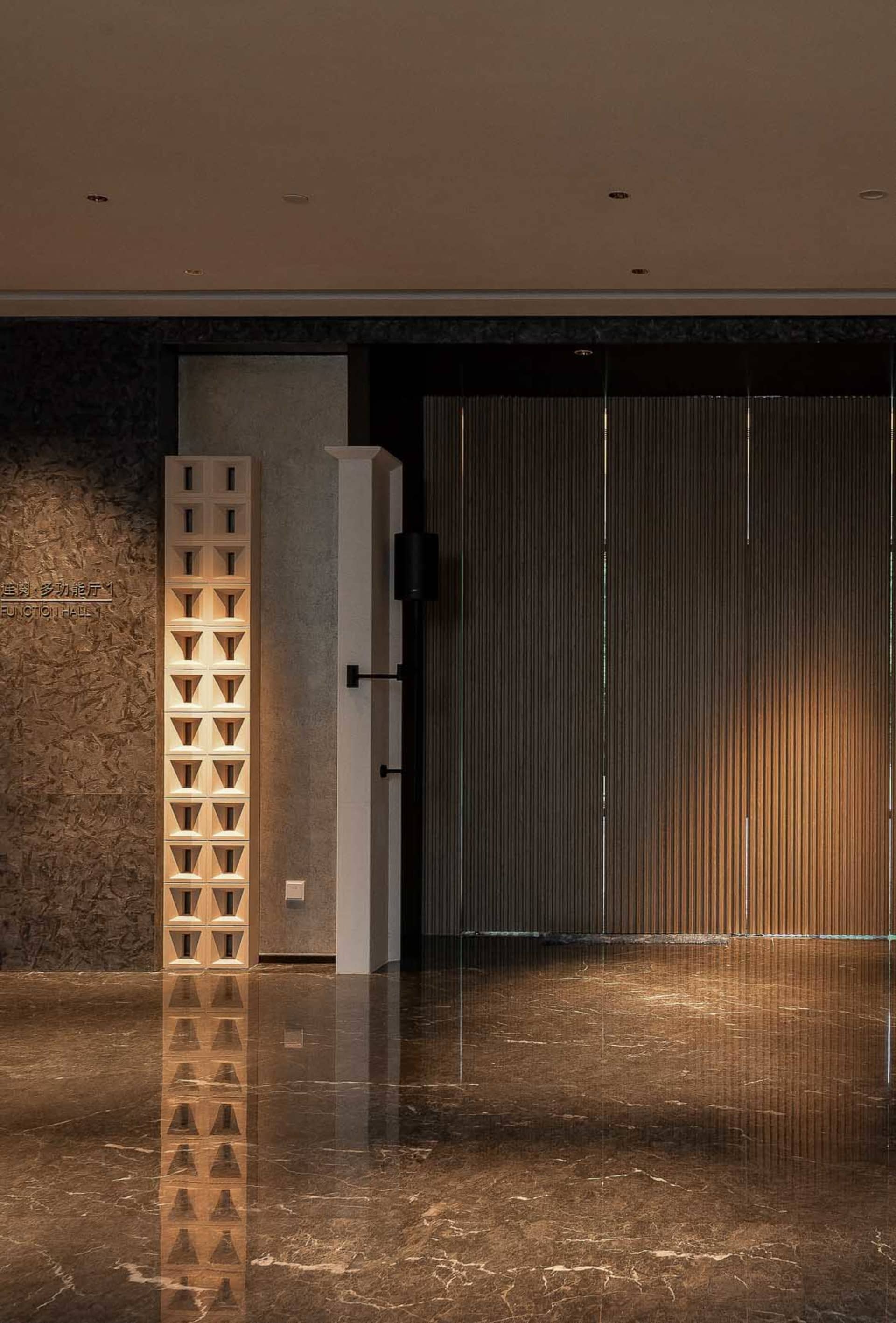 A modern, spacious conference hall with polished wooden paneling.