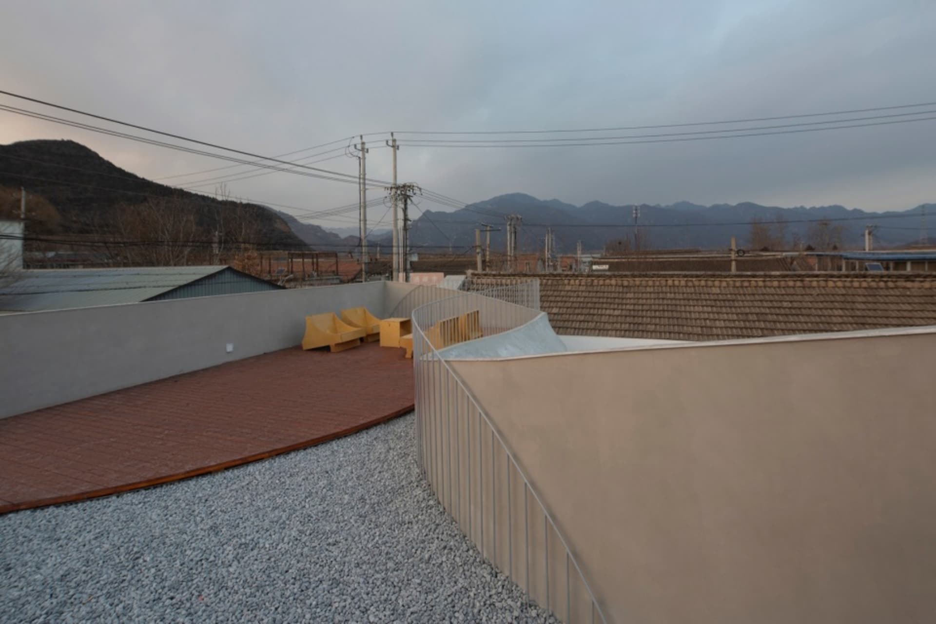 Modern outdoor space featuring brick patio and gravel surround