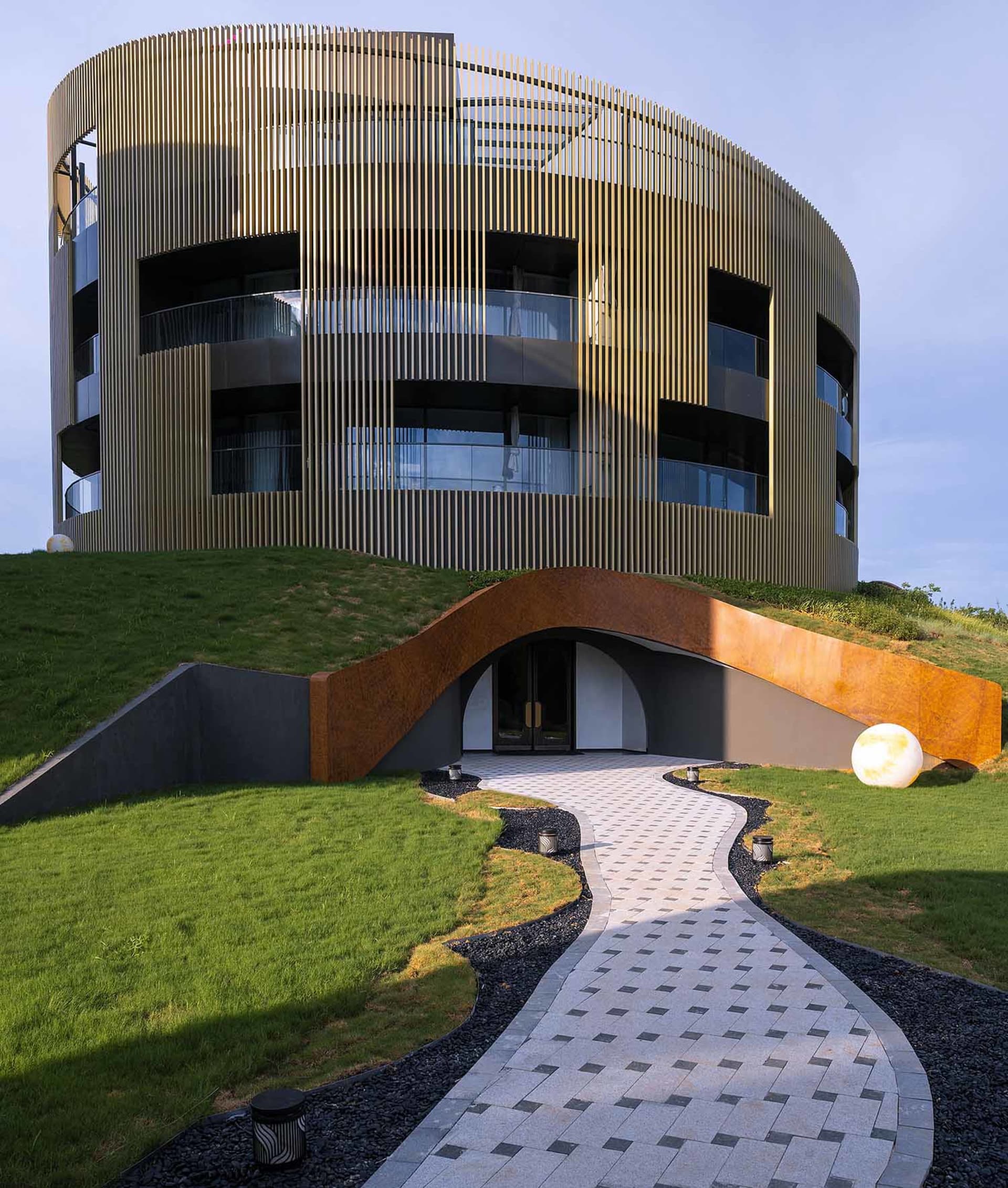 A modern residential building with metal cladding and glass windows.
