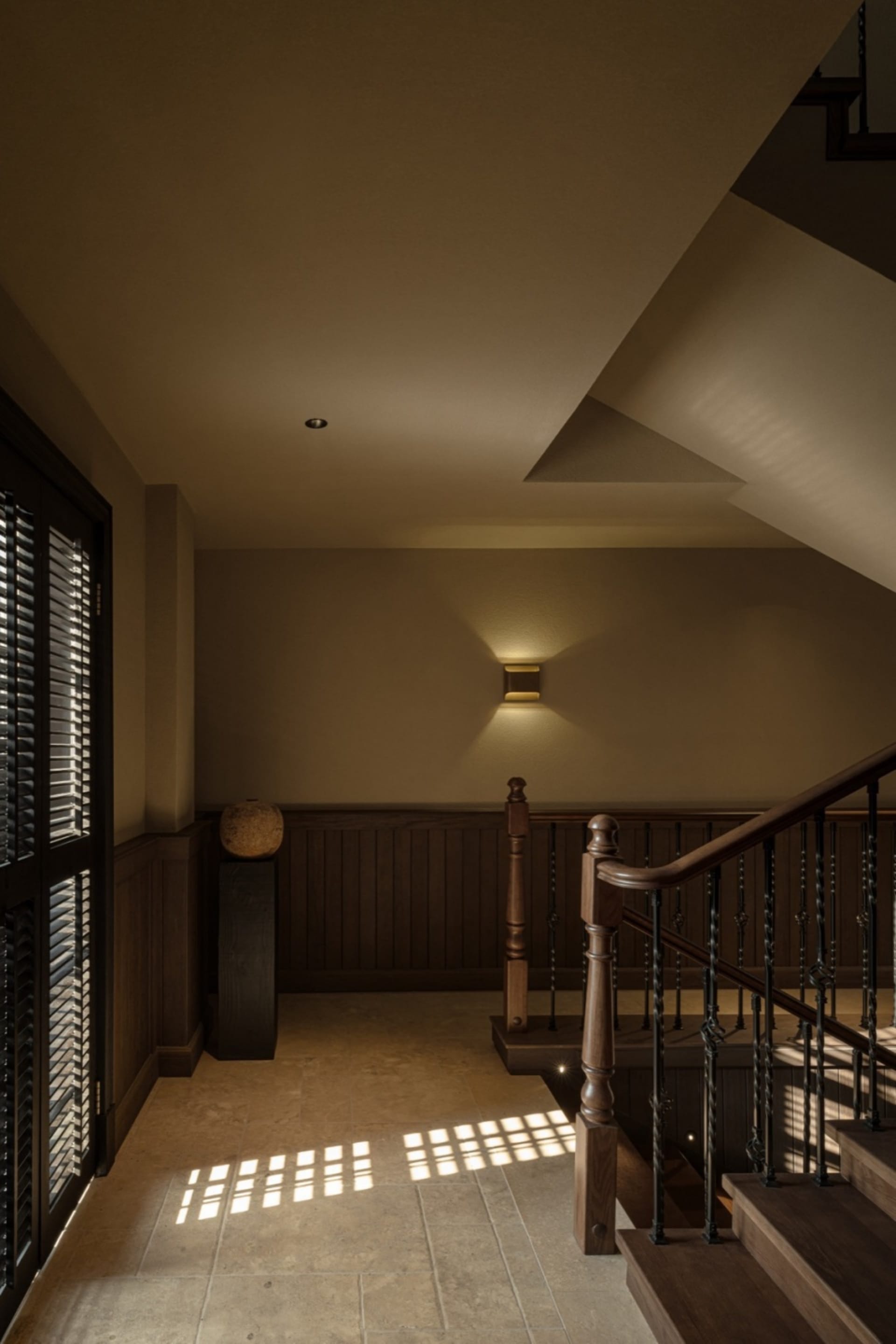 A modern staircase with wooden railings and illuminated by wall-mounted lights against a warm, neutral background.