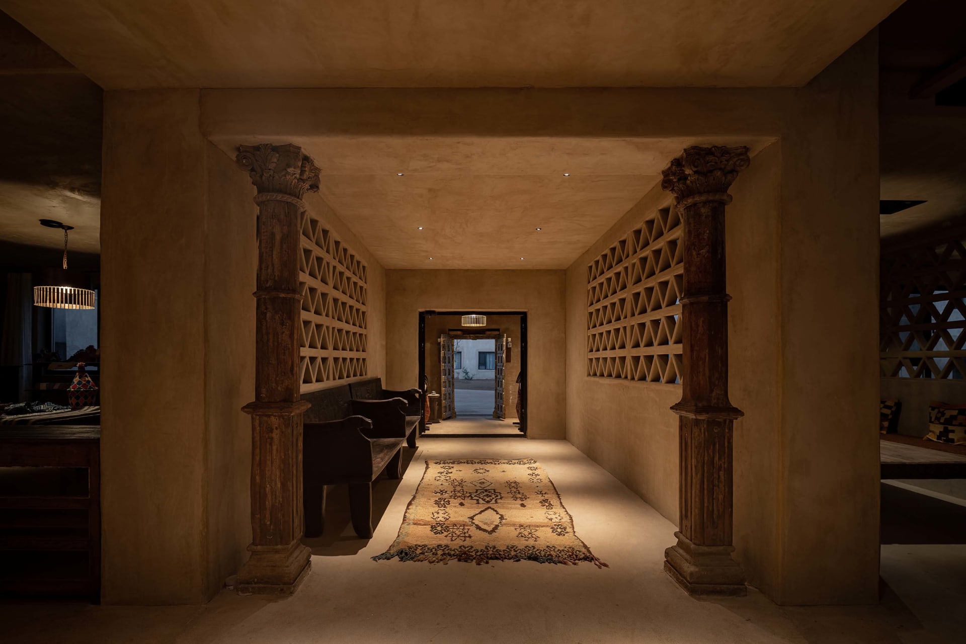 A modern residential hallway featuring concrete walls and flooring.