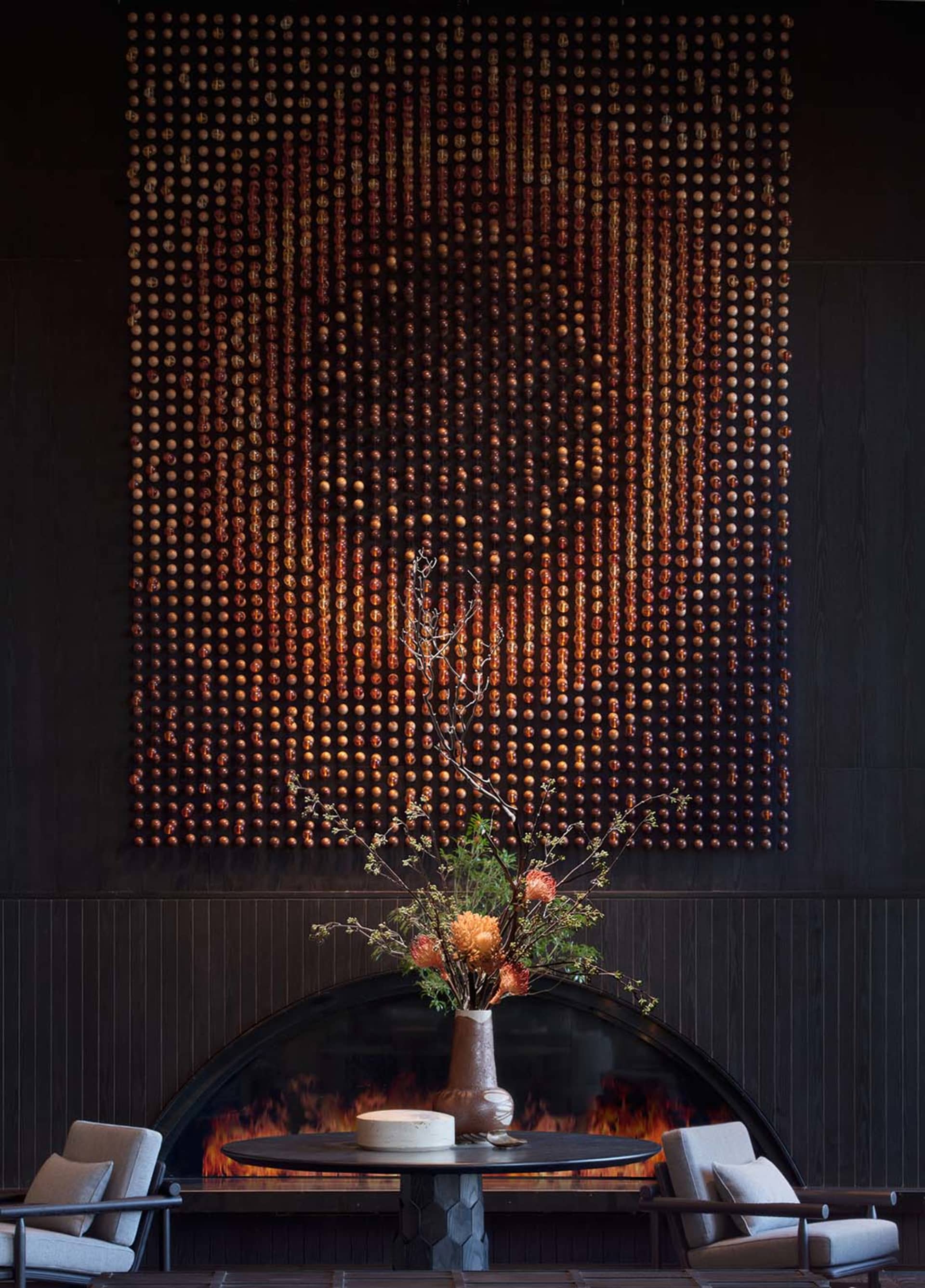 A contemporary lobby featuring metal elements and intricate wall art.