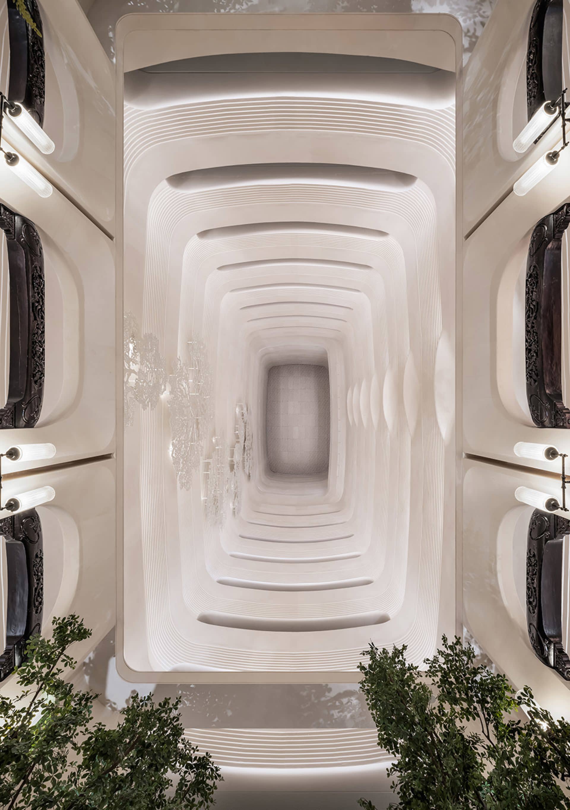 An elegant architectural interior with concrete walls and light fixtures.