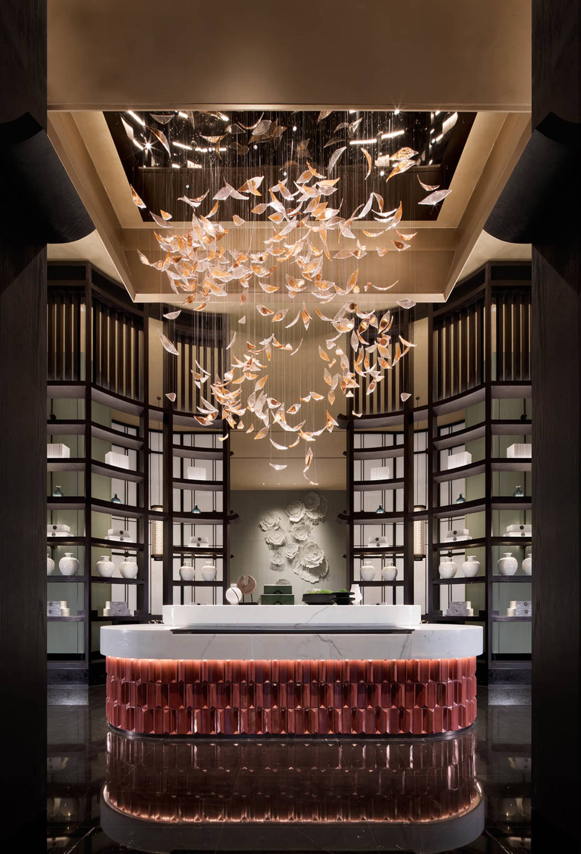 A luxury reception desk featuring elegant, artistic glass elements.