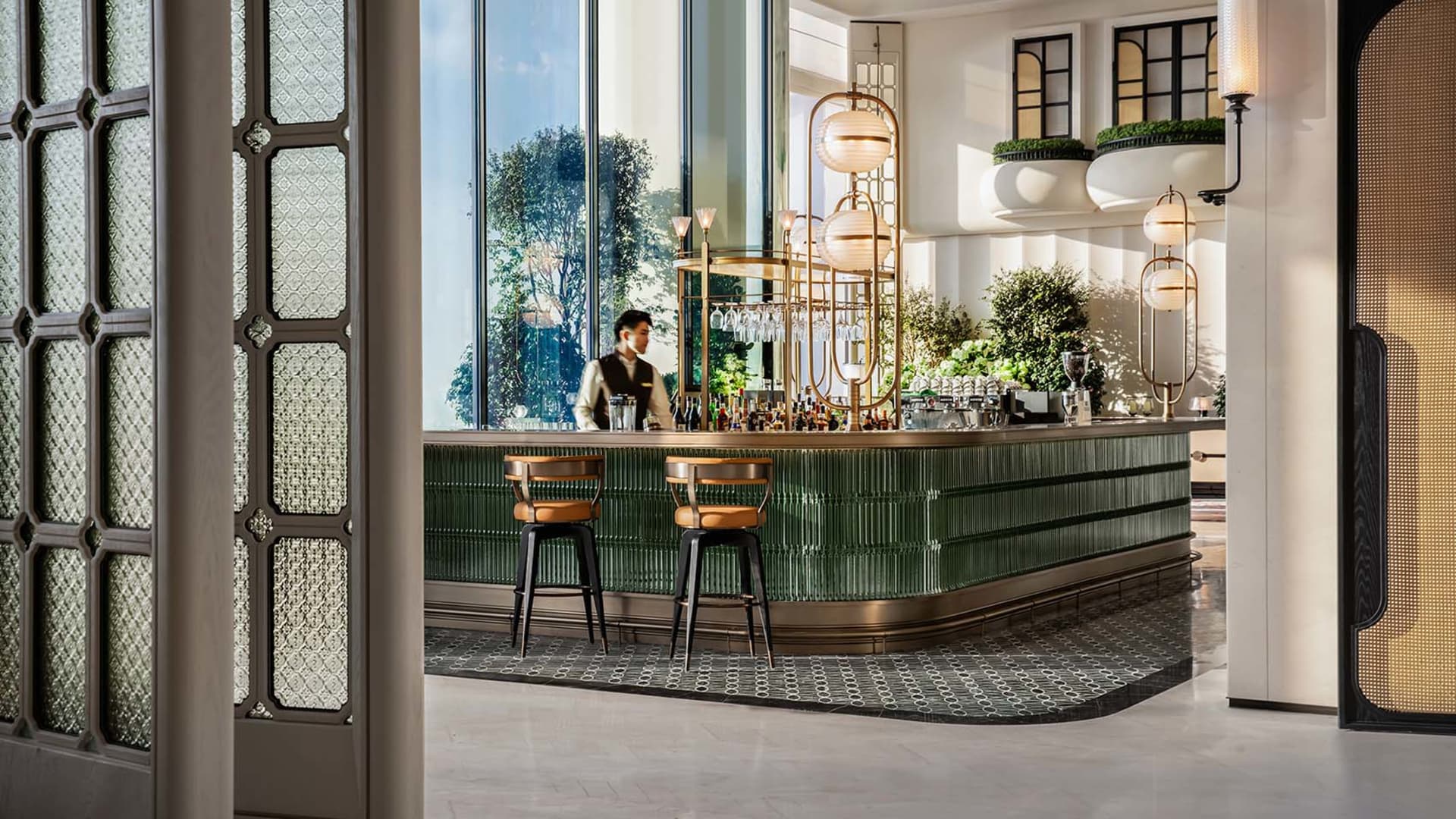 A modern bar with a mid-century design featuring metal and glass materials.