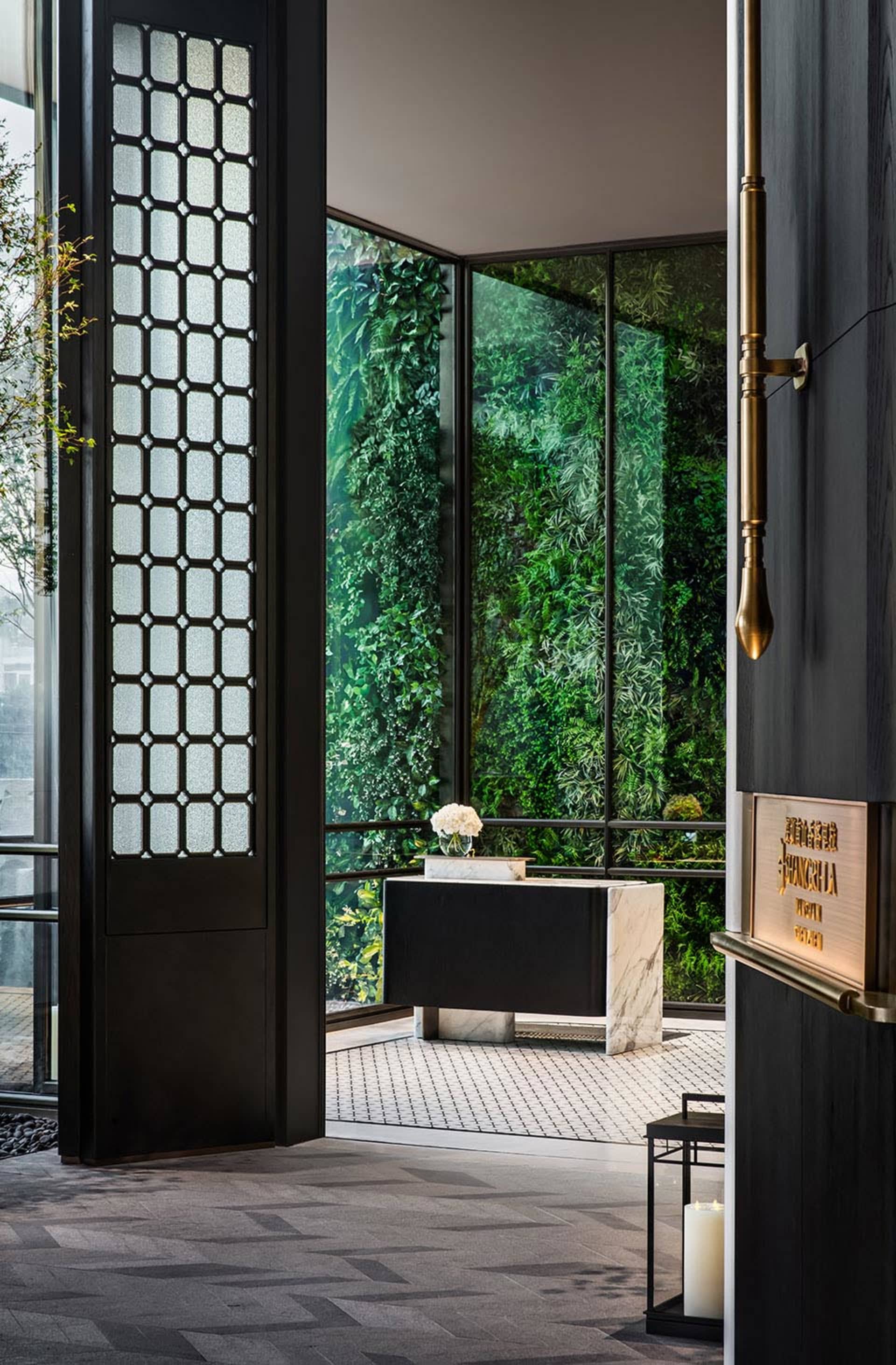 Modern entrance featuring glass walls and marble accents