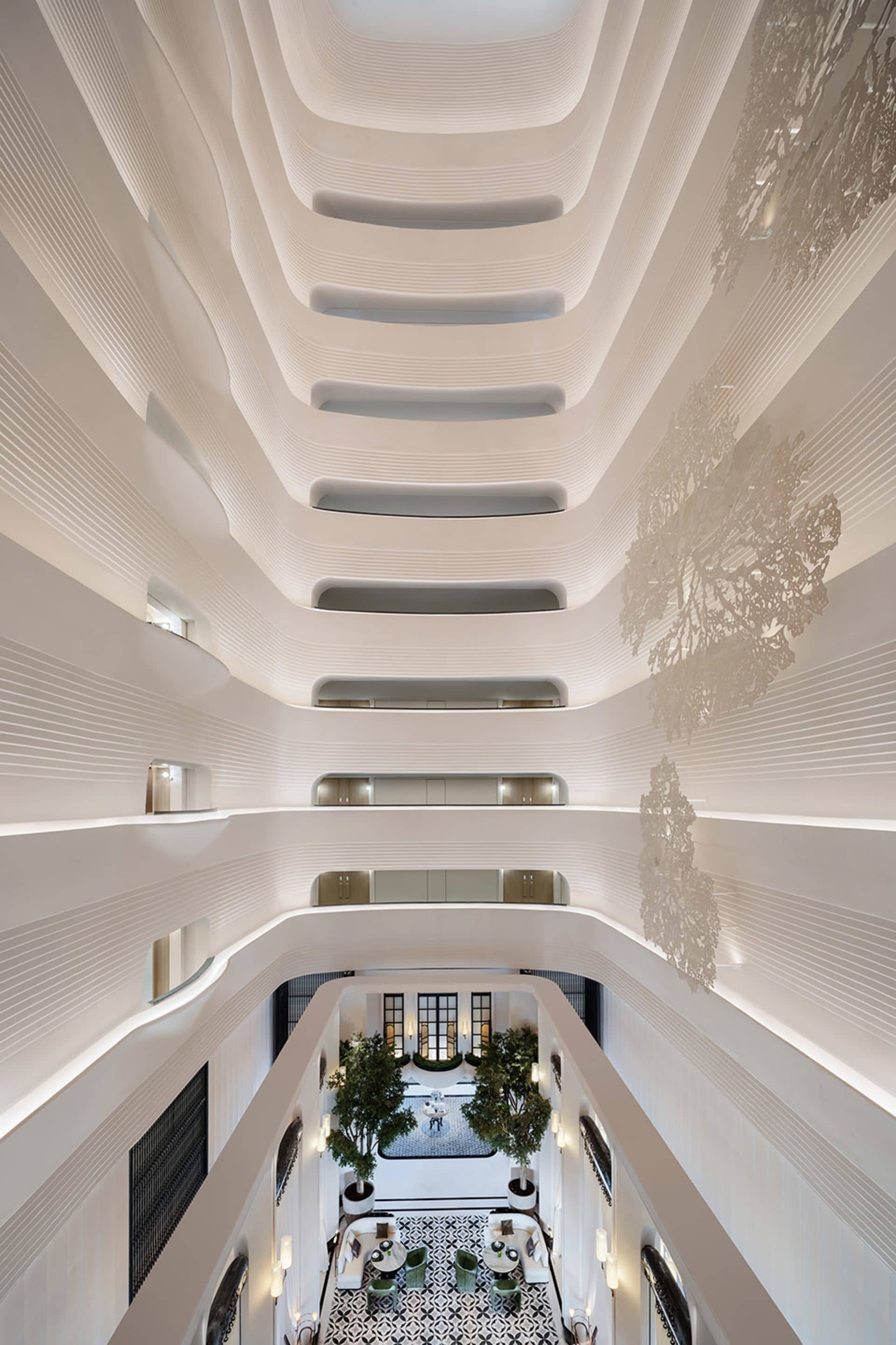 Modern hotel lobby with white marble, glass, and metal accents