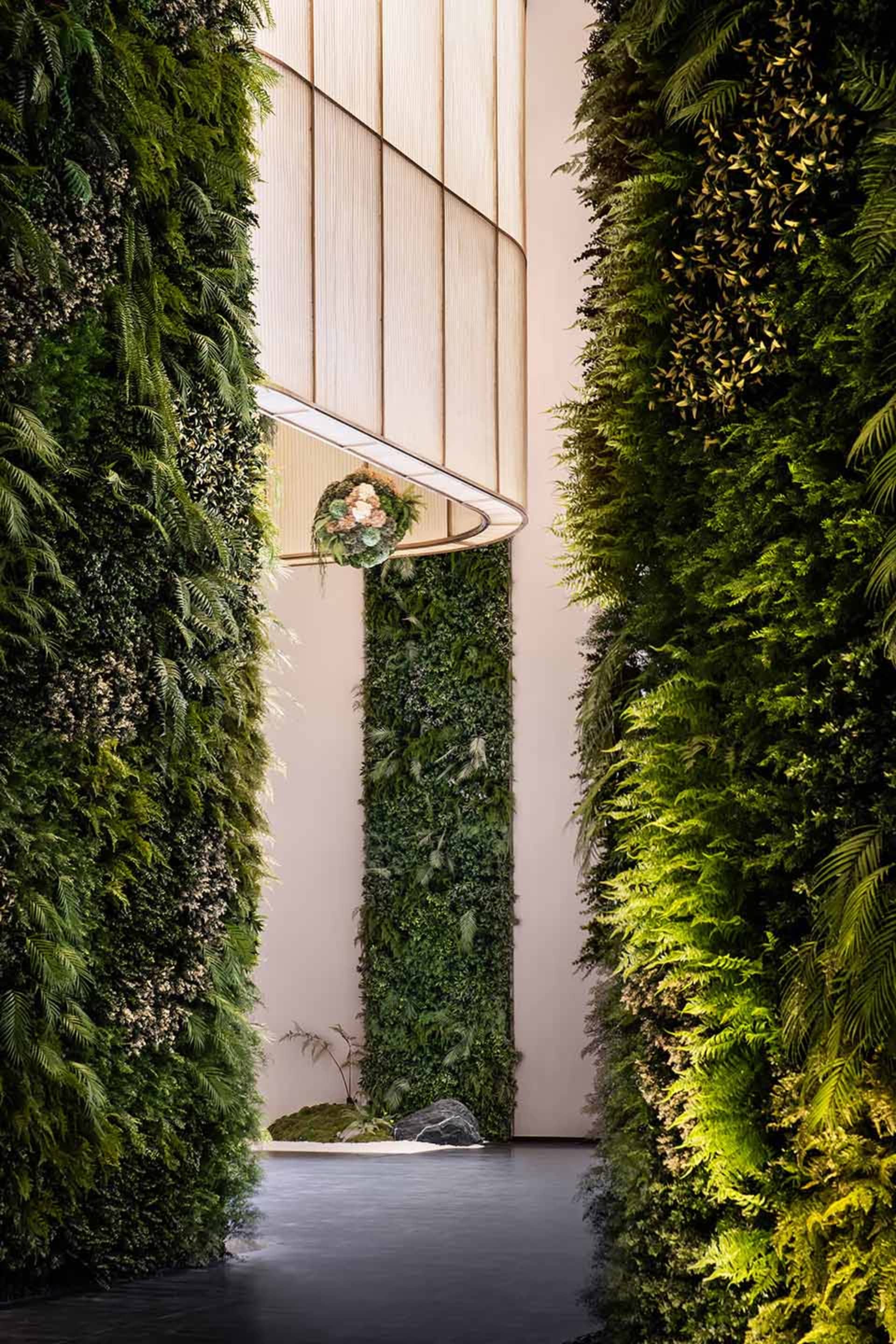 A modern interior living room featuring green plants on the walls.