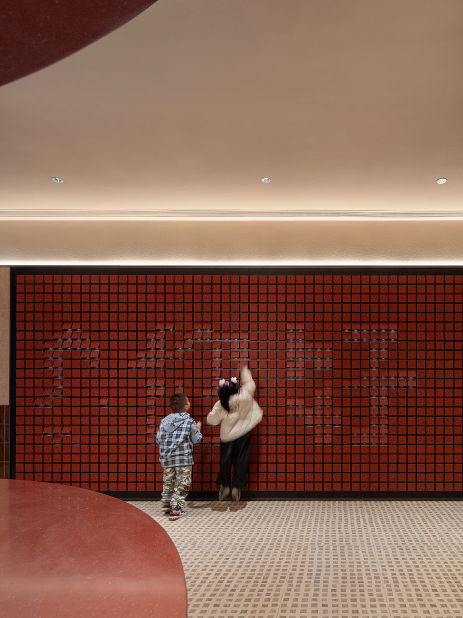 Children playing on a tile playground.