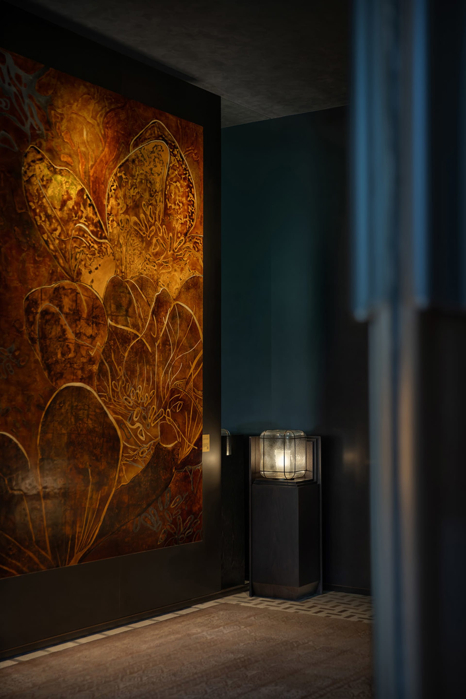 A modern minimalist lobby featuring metallic wall art