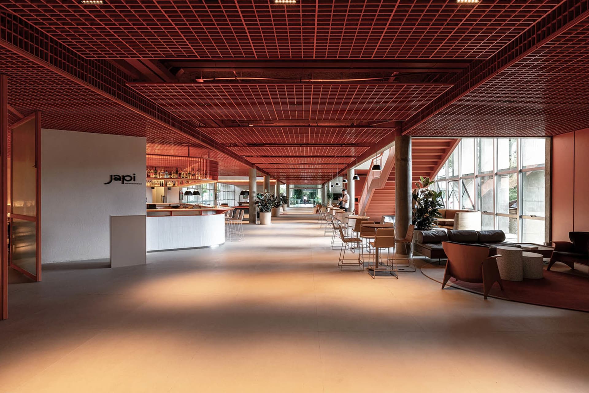 A spacious modern restaurant interior featuring a terrazzo floor and contemporary design elements.