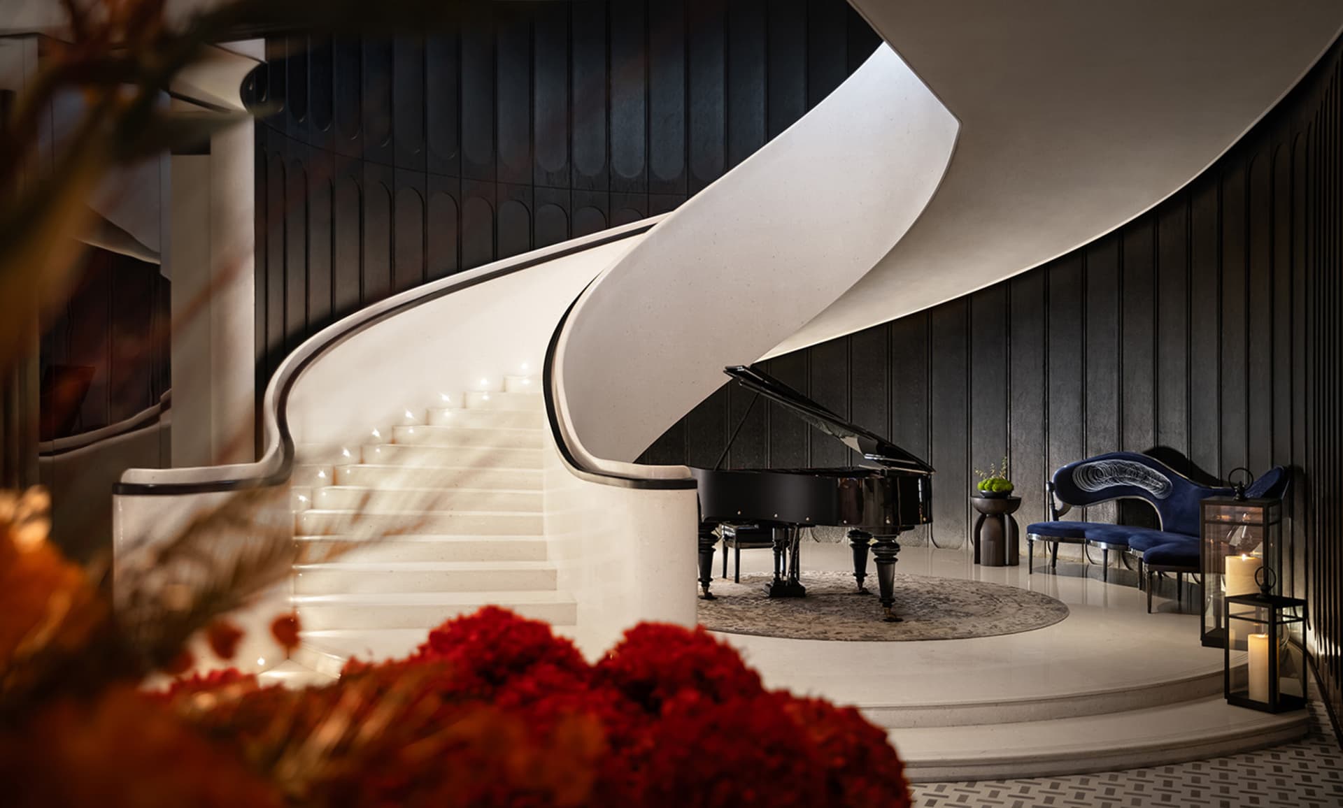 A luxurious white marble living room with a grand piano, floral decor, and elegant seating arrangements.