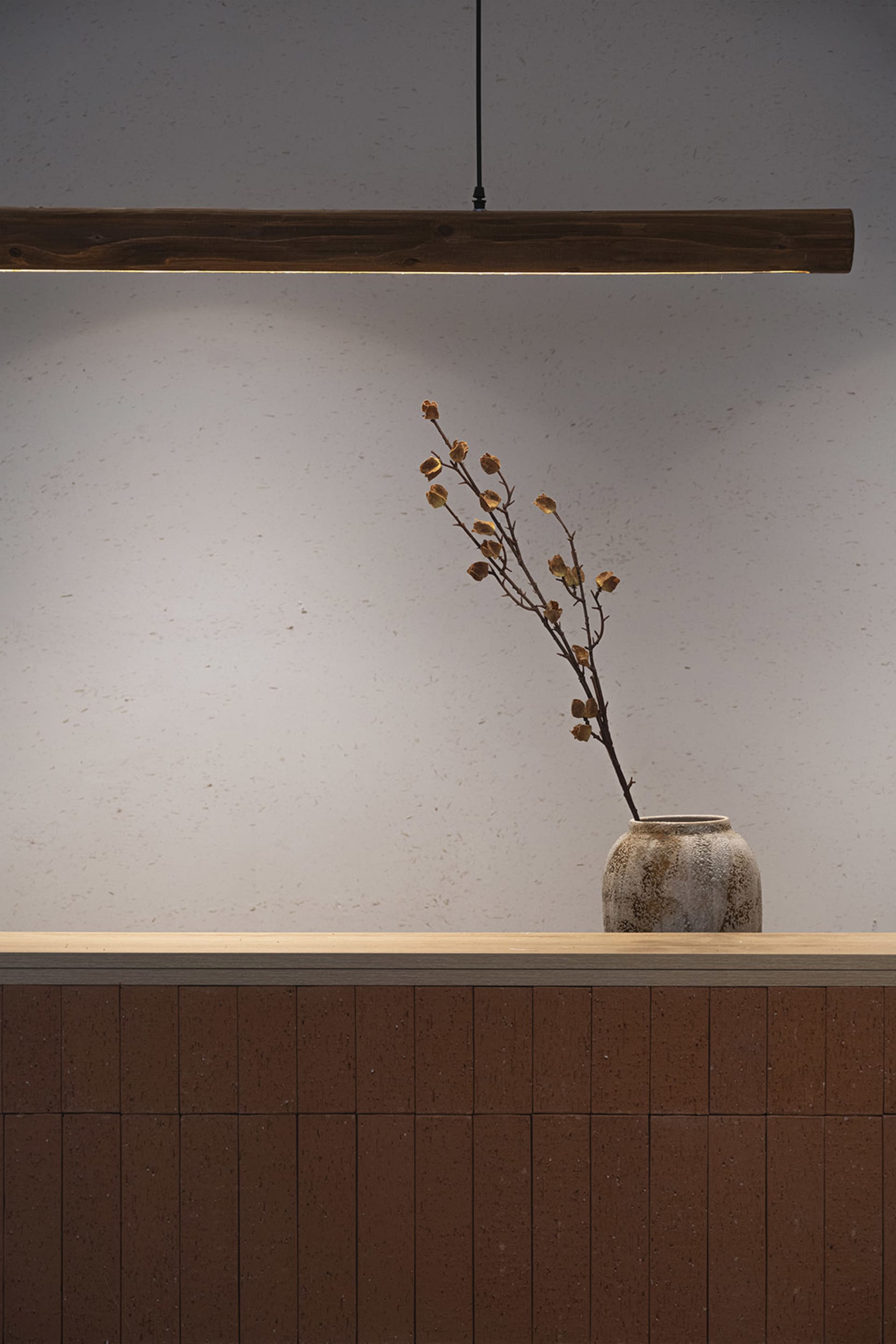Decorative arrangement featuring dried flowers in a minimalist setting with terracotta elements.
