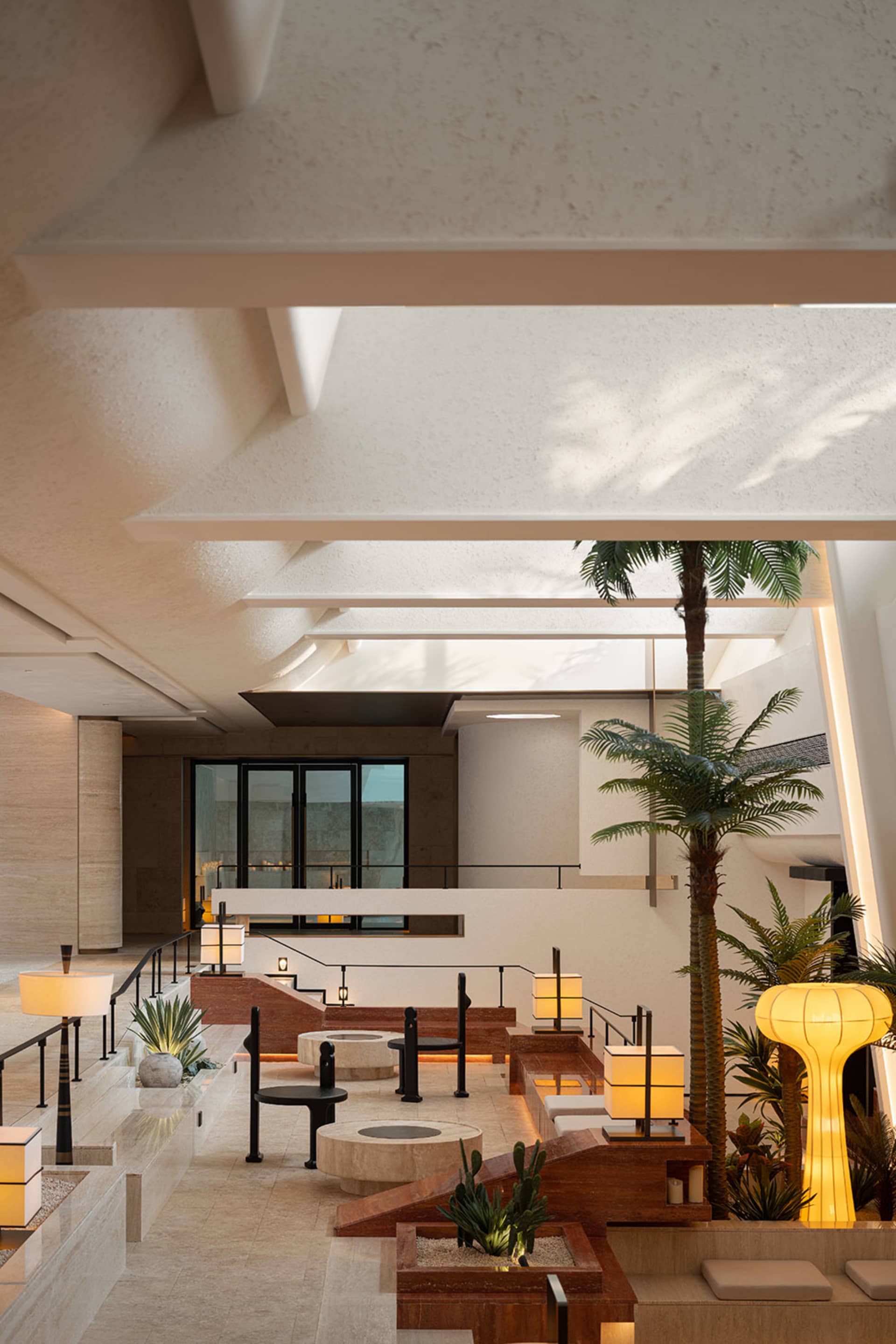 A modern lobby with concrete, wood, and glass elements.