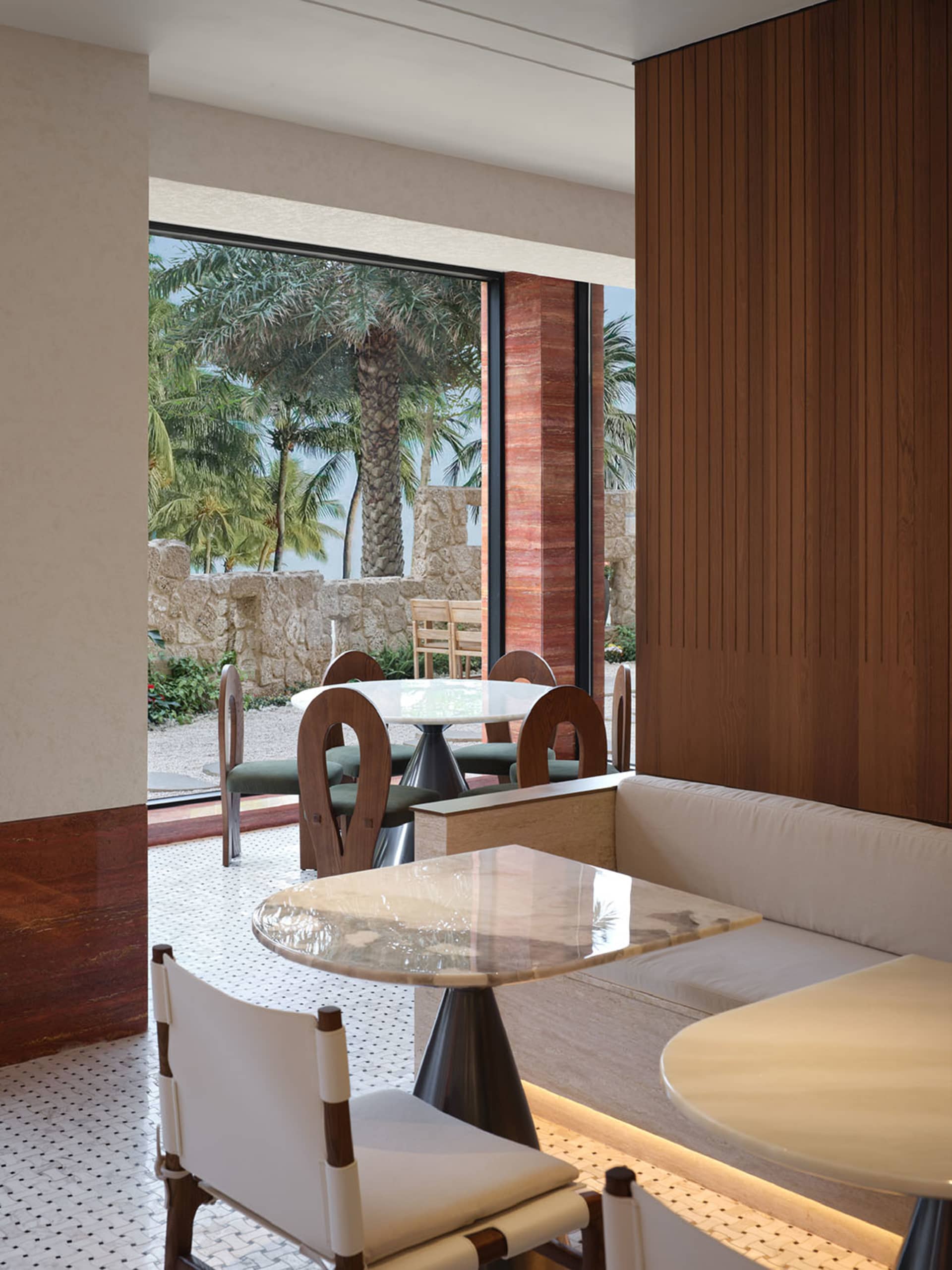 Modern restaurant interior with marble seating and white flooring.
