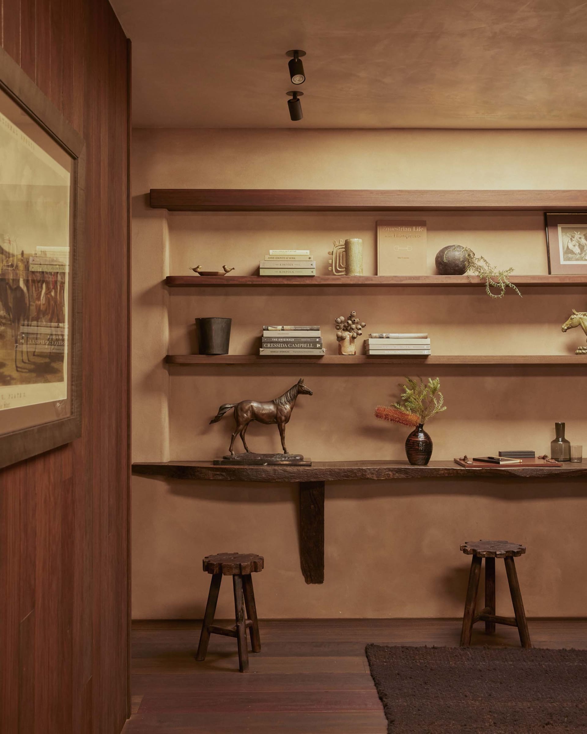 A set of wooden floating shelves adorned with books, vases, and other decorative items.