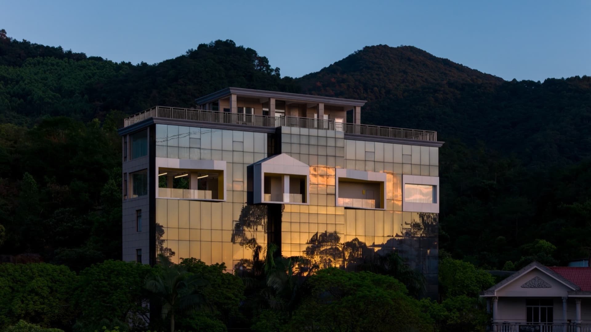 Modern residential building exterior with glass facade