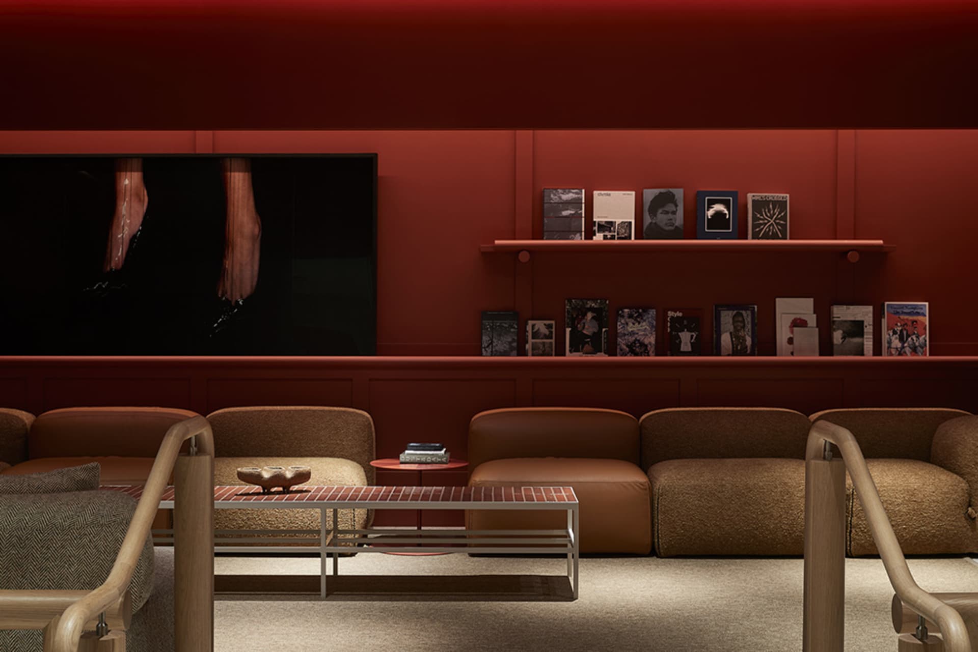 A modern living room featuring fabric upholstery, wooden accents, and metallic elements.