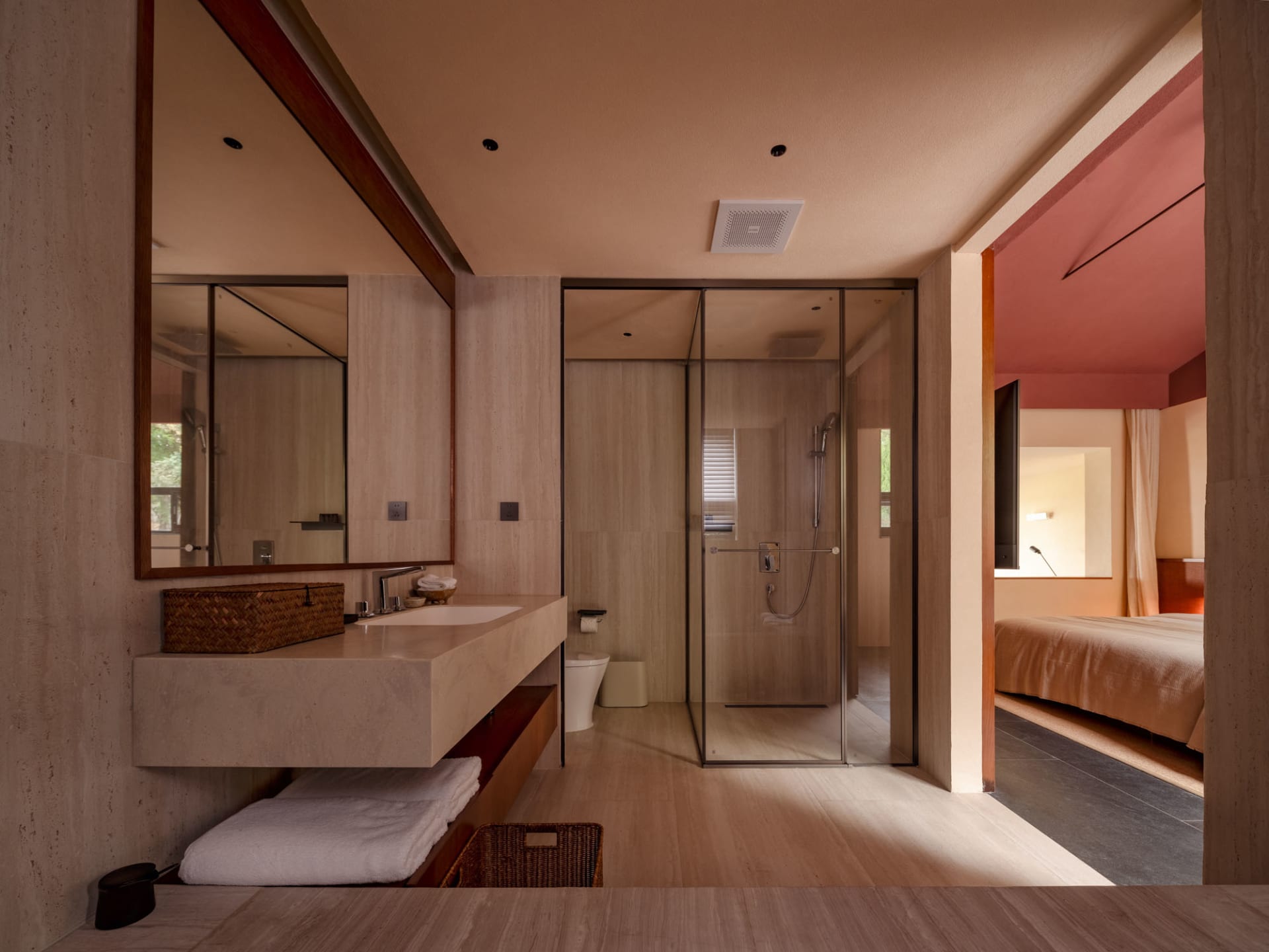A modern bathroom featuring minimalist design with tile walls and floor.