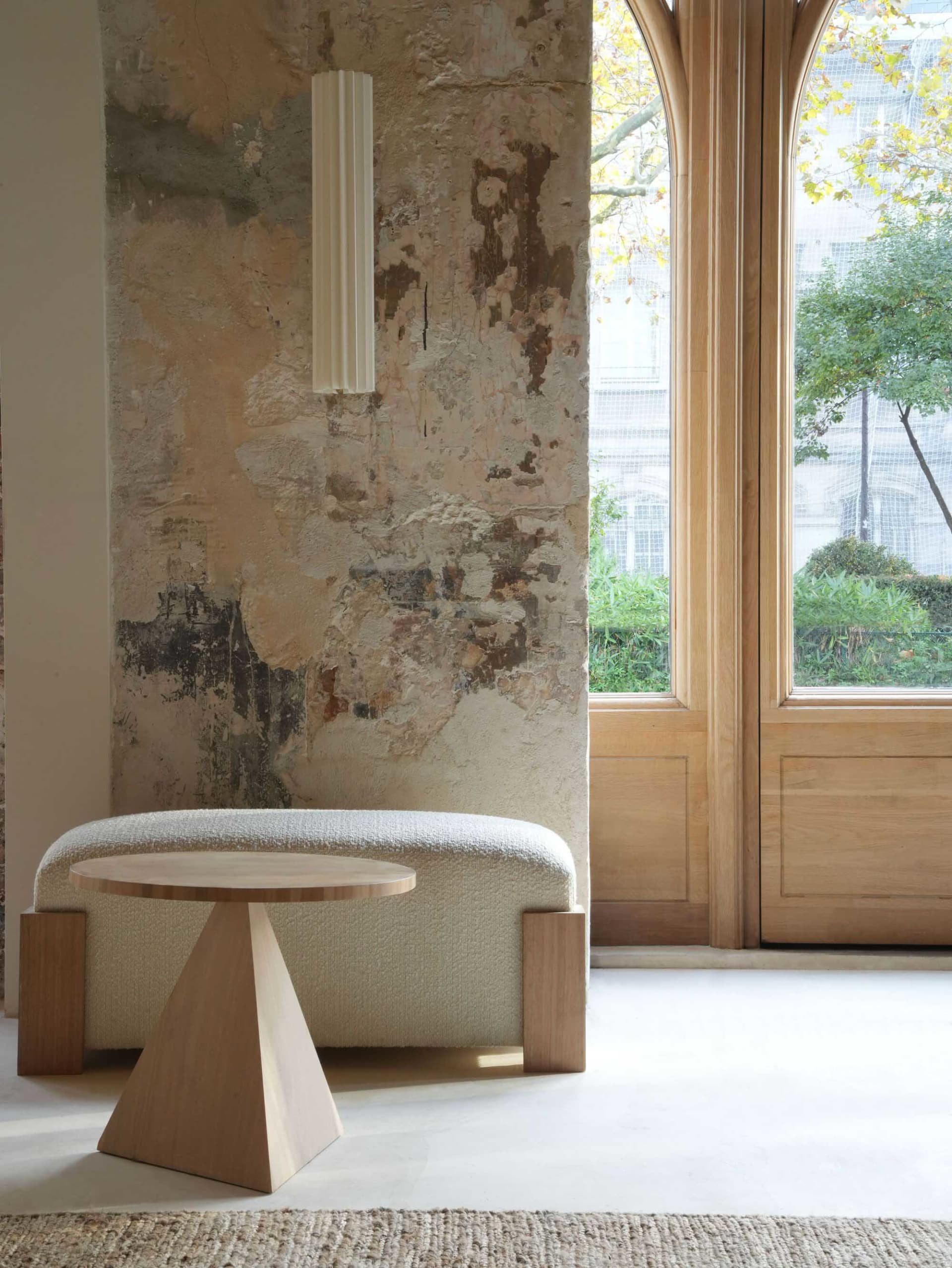 A modern living room with wooden furniture and a textured wall
