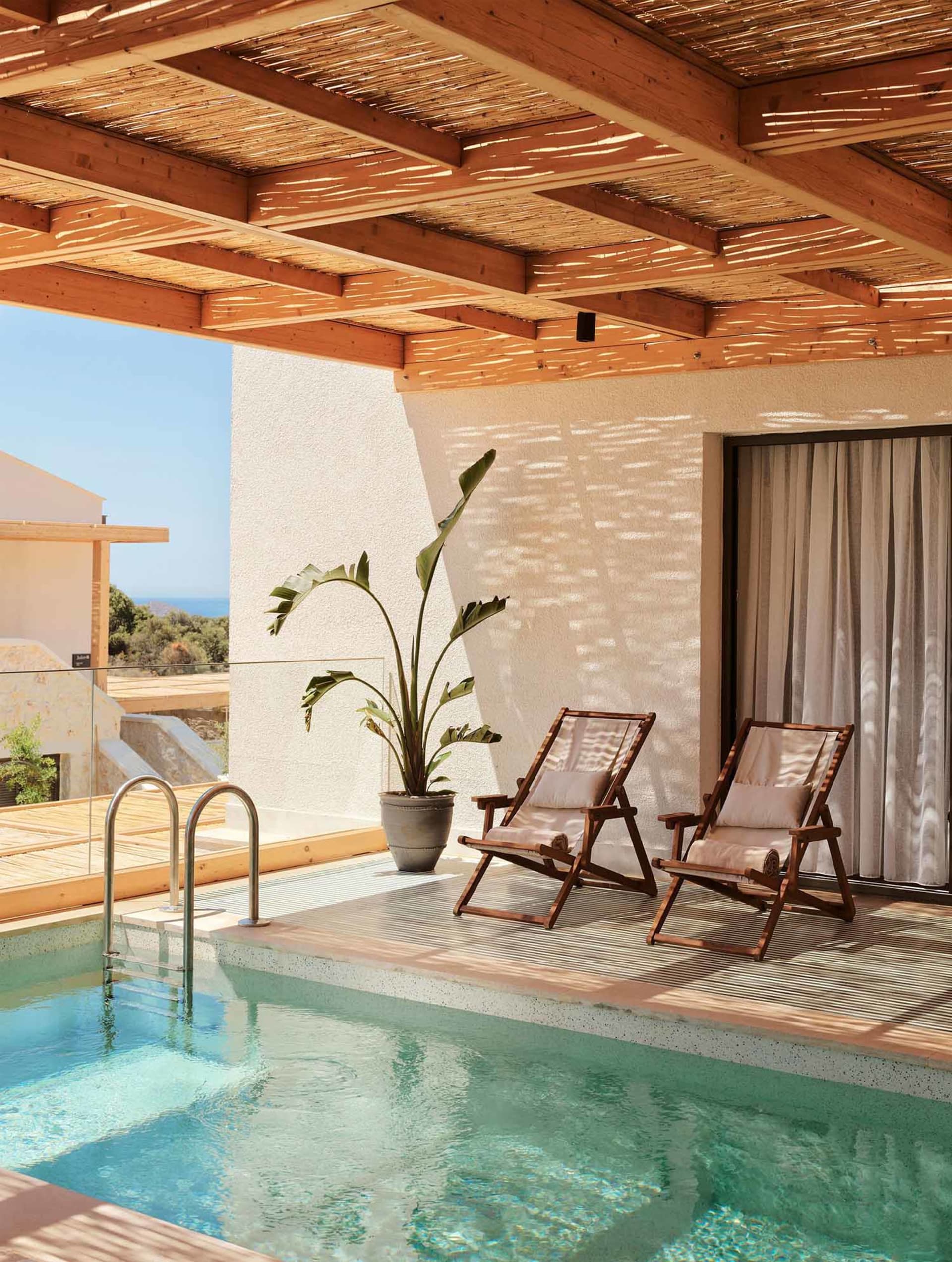 Terra-Minimalist Swimming Pool Terrace with Wooden Furniture and Bamboo