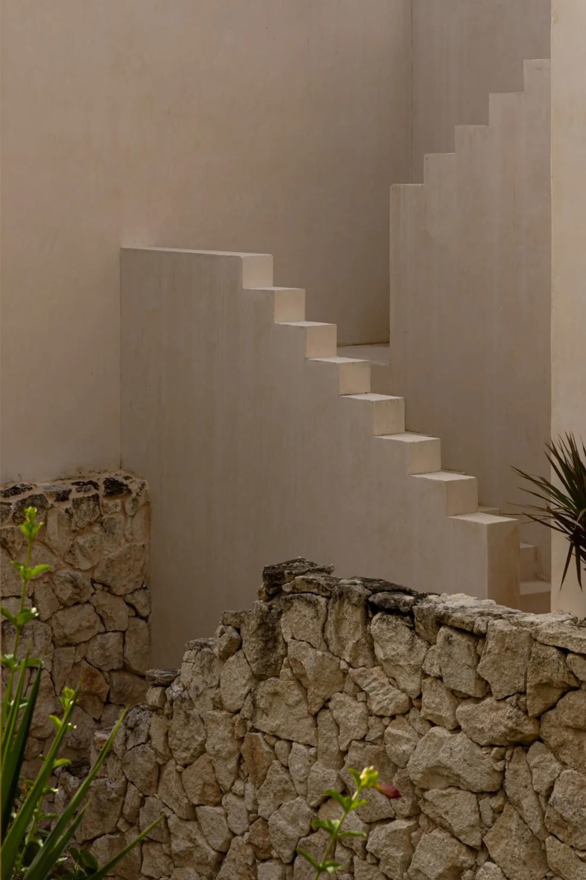 A modern interior space with stone walls and steps
