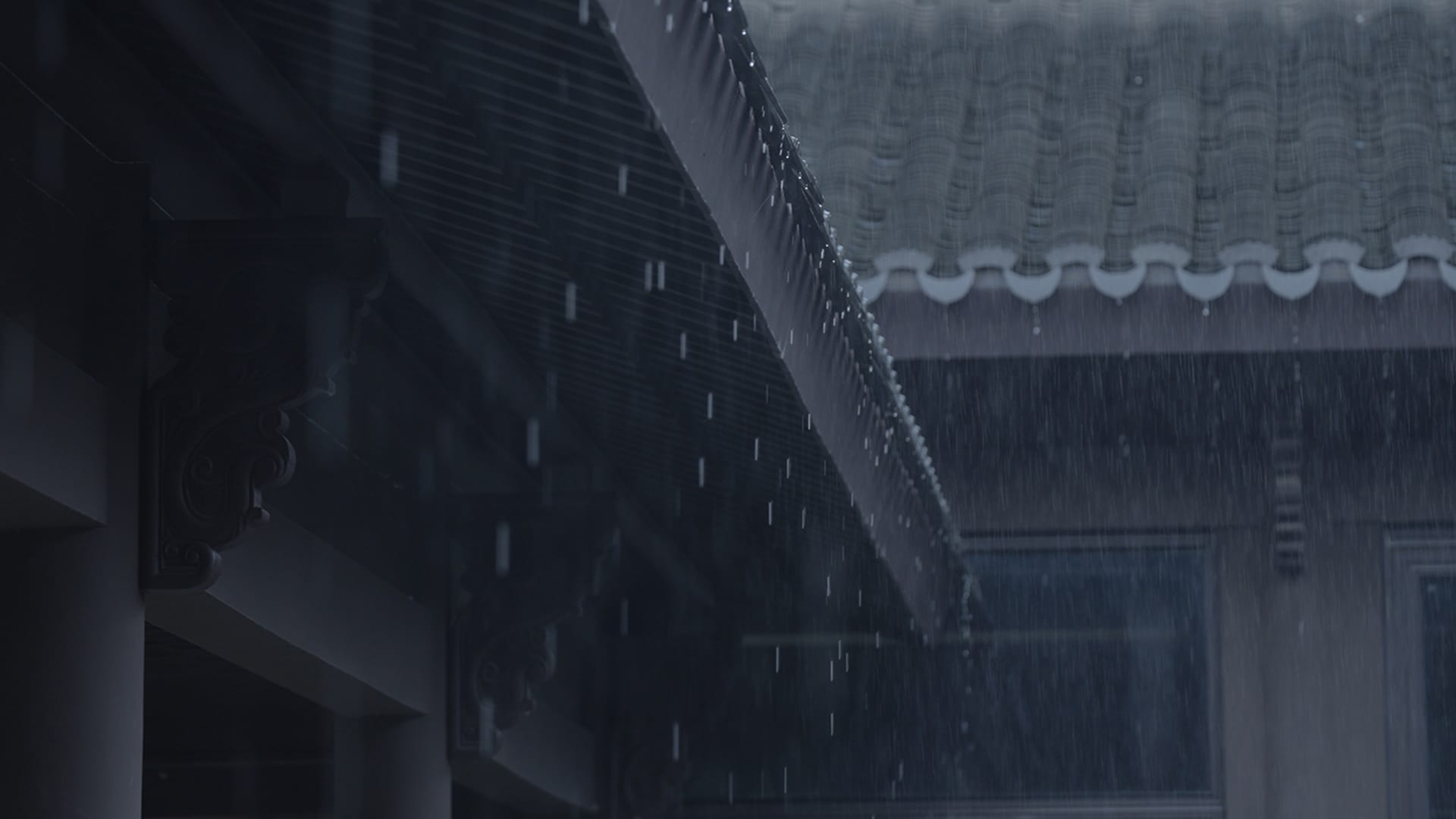 Rice field with rain dripping down from a tiled roof and wooden gutters.
