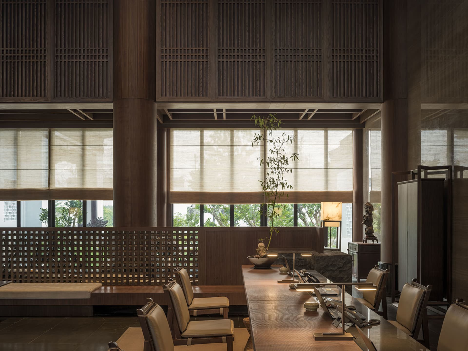 Modern office space featuring wooden furniture and high ceilings.