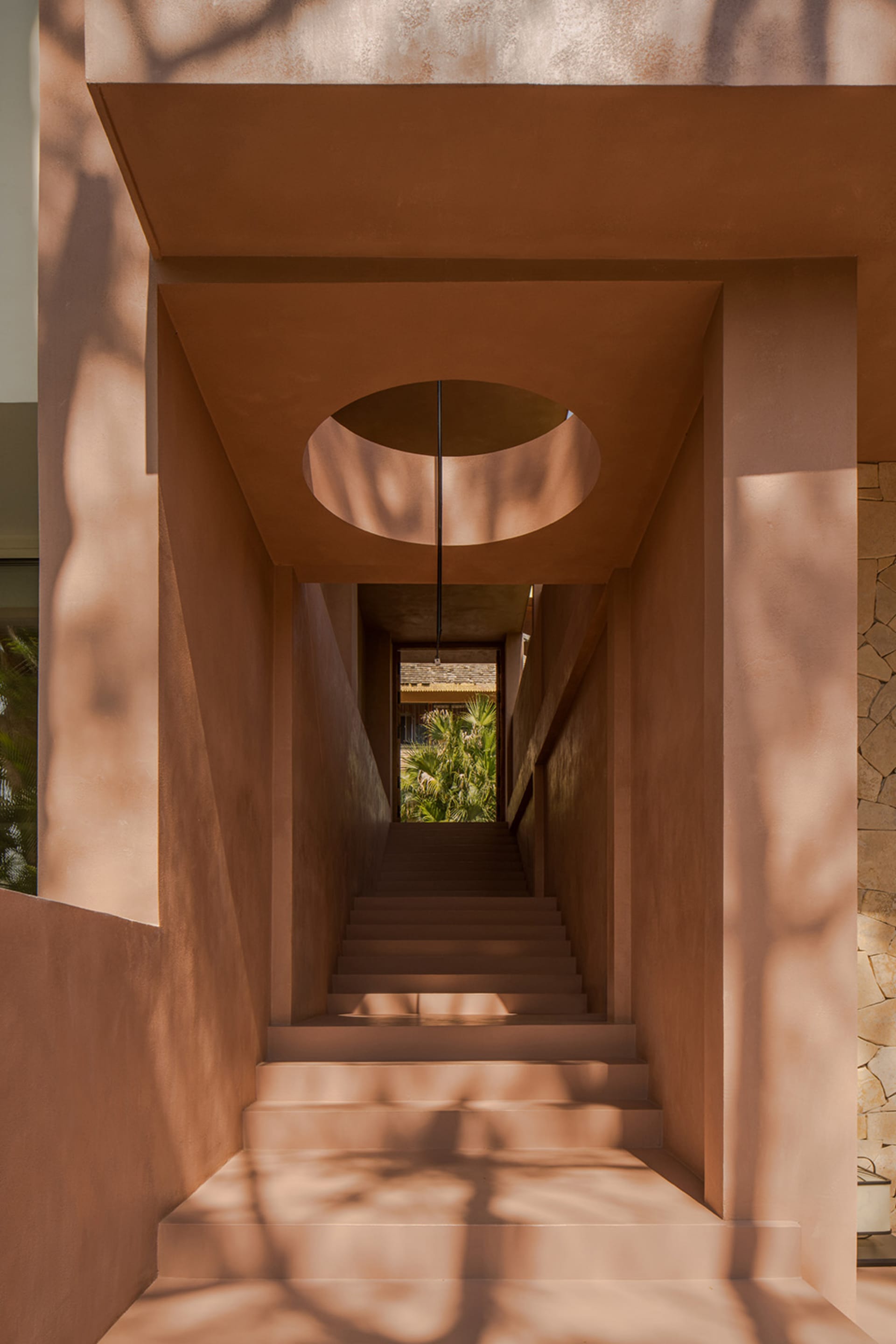 Stairway with clay walls and circular window