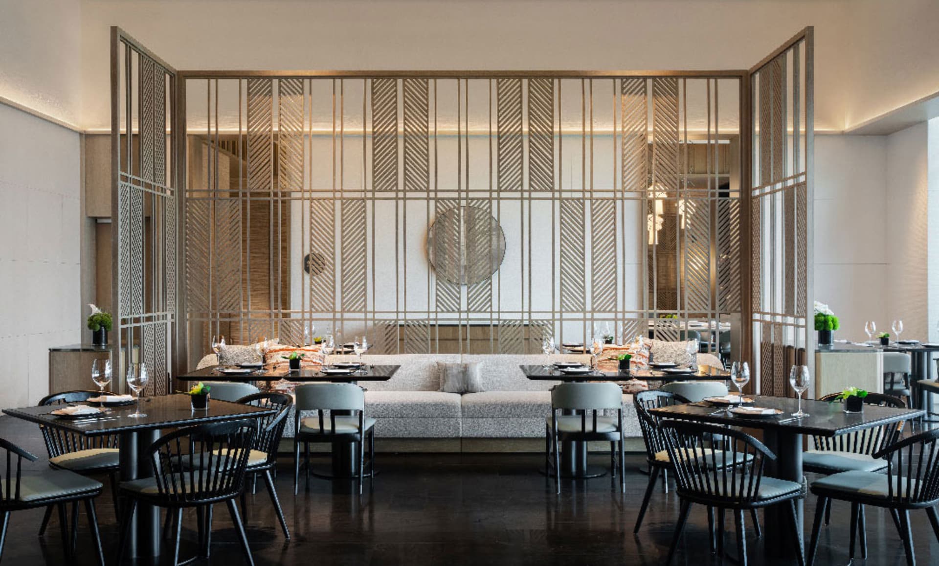 A modern restaurant interior with metallic, glass, and wooden elements.