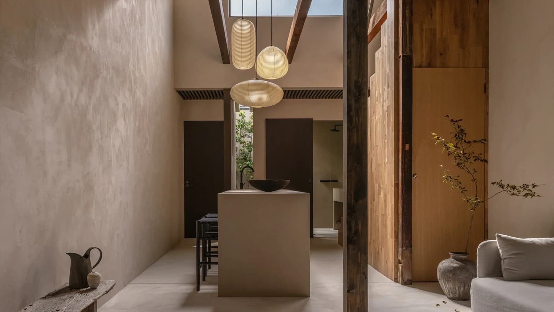 A modern residential interior featuring concrete walls and wooden elements.
