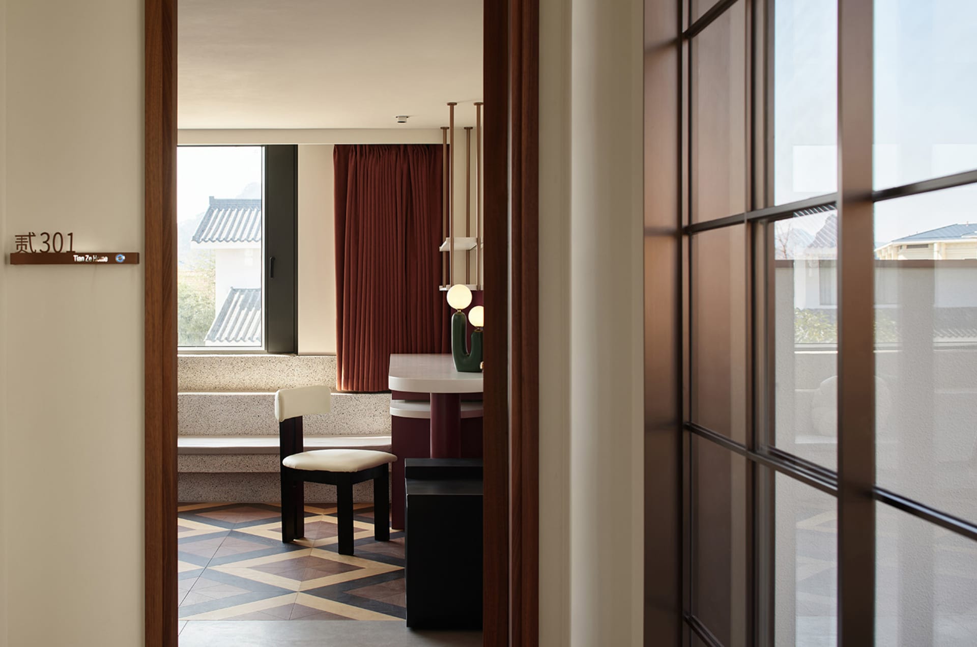 A modern residential room with wooden furniture, ceramic floor tiles, and minimalist decor.
