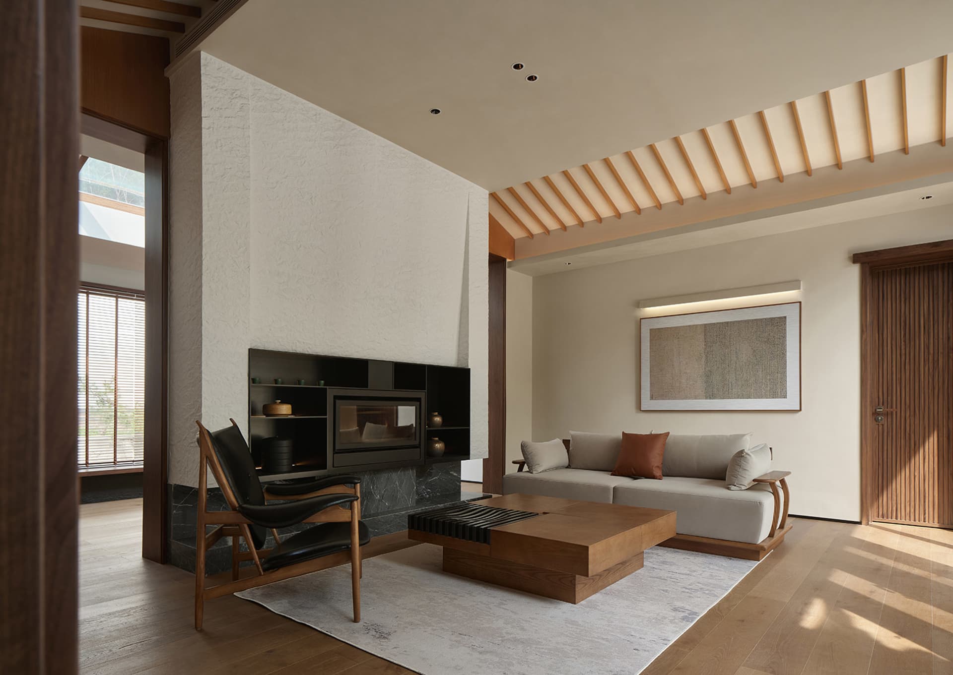 Modern living room with white walls, wooden flooring, and minimalist decor.